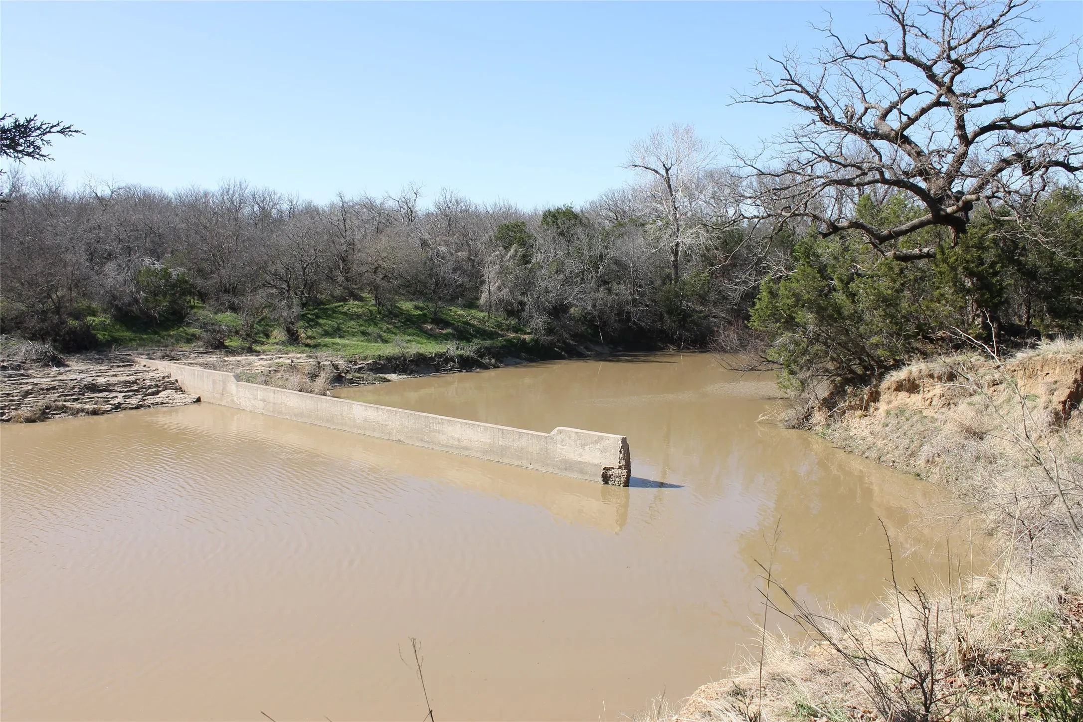 Part of a dam that was constructed at one time.  Potentially could be re-engeneered to finish the dam