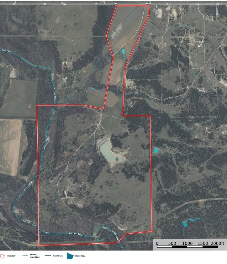  Aerial outlining the property boundary, water features, and surrounding terrain