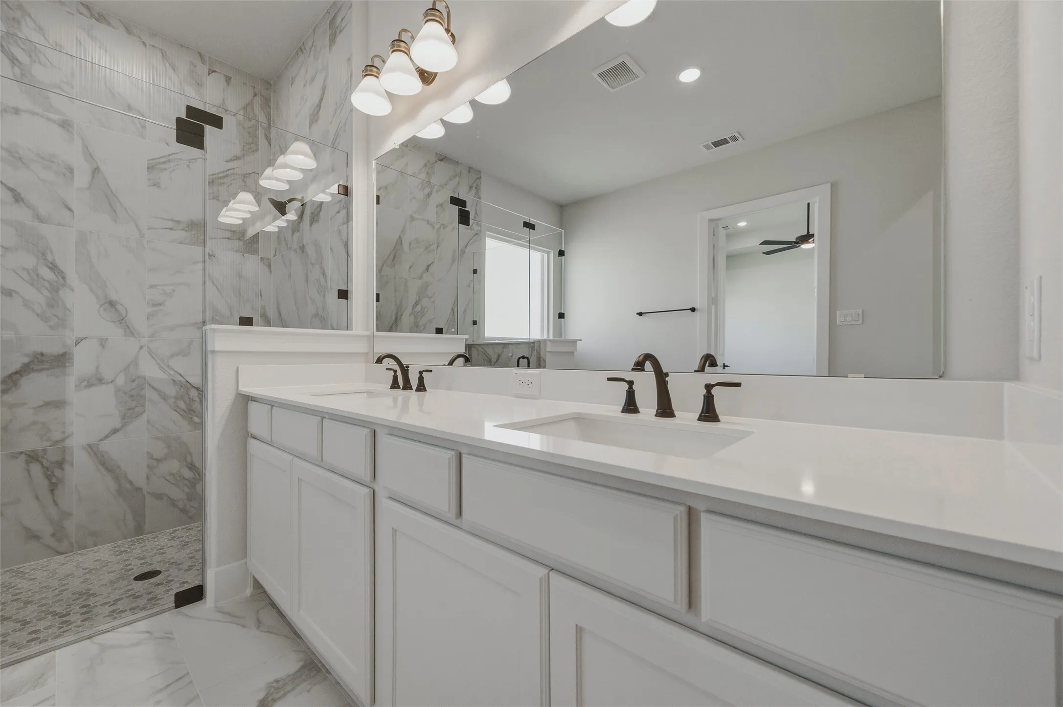 Dual vanity with white cabinetry and integrated sinks