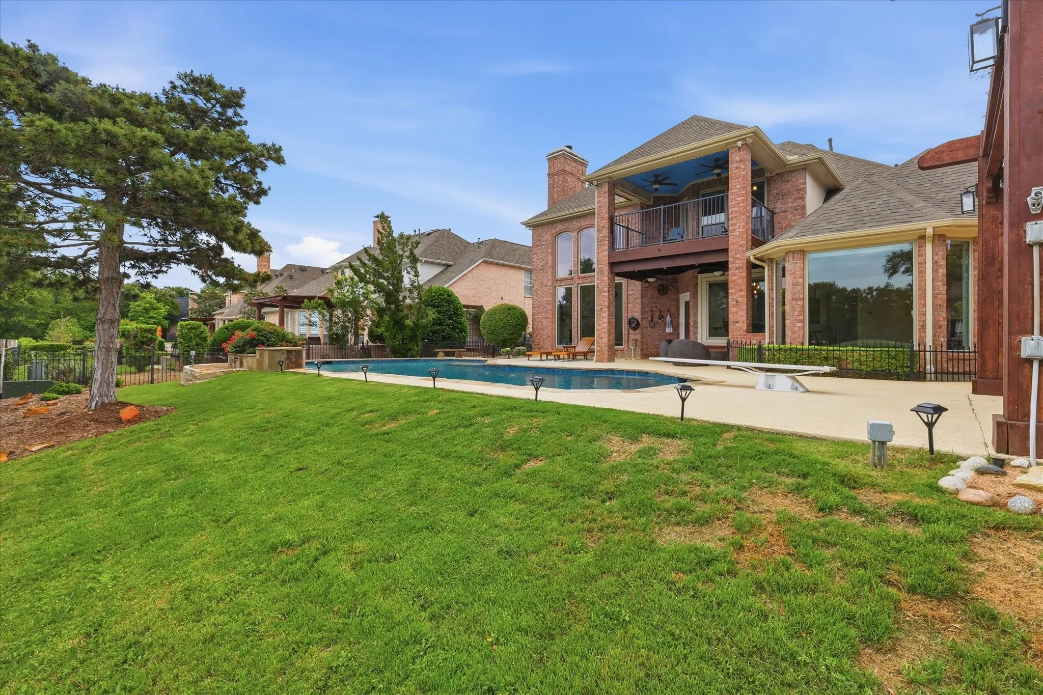 Brick exterior with a multi-level balcony and expansive windows