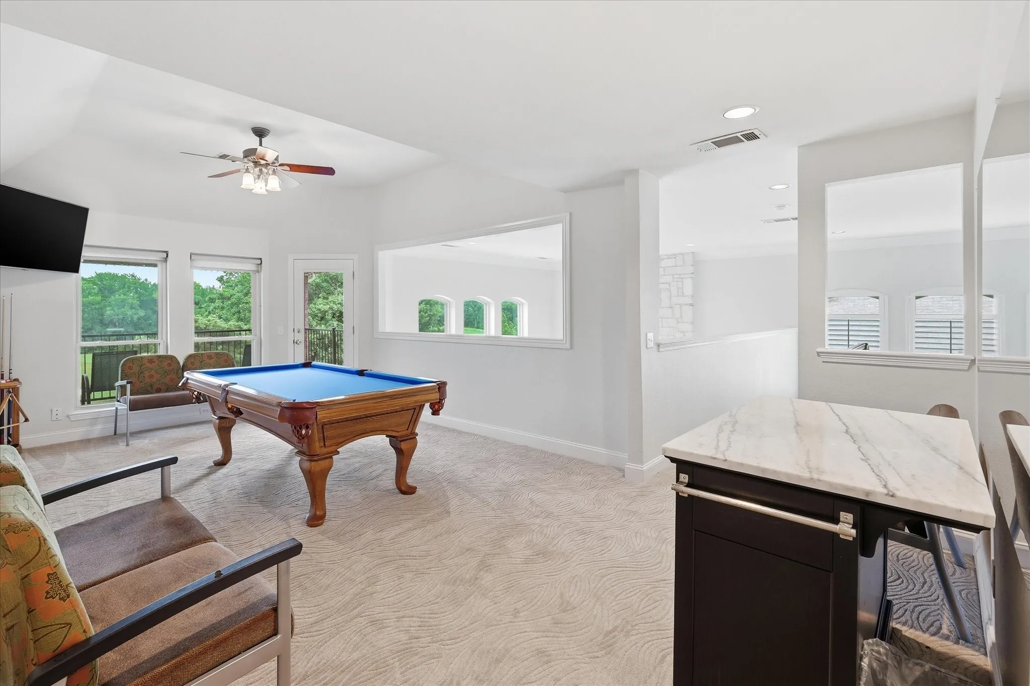 Expansive bonus room featuring vaulted ceilings, recessed lighting, and soft patterned carpeting
