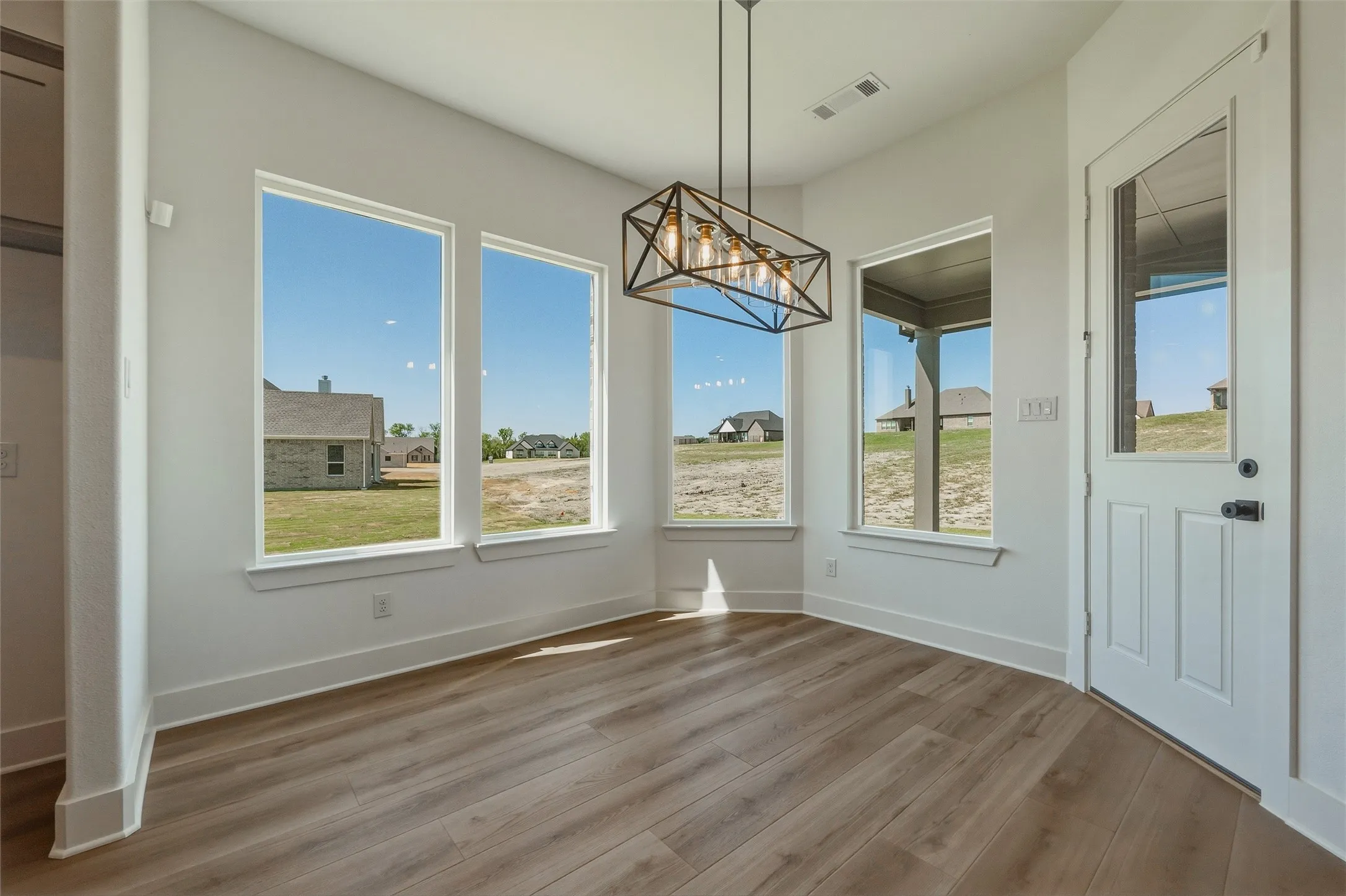 Wood-finish flooring with white baseboards