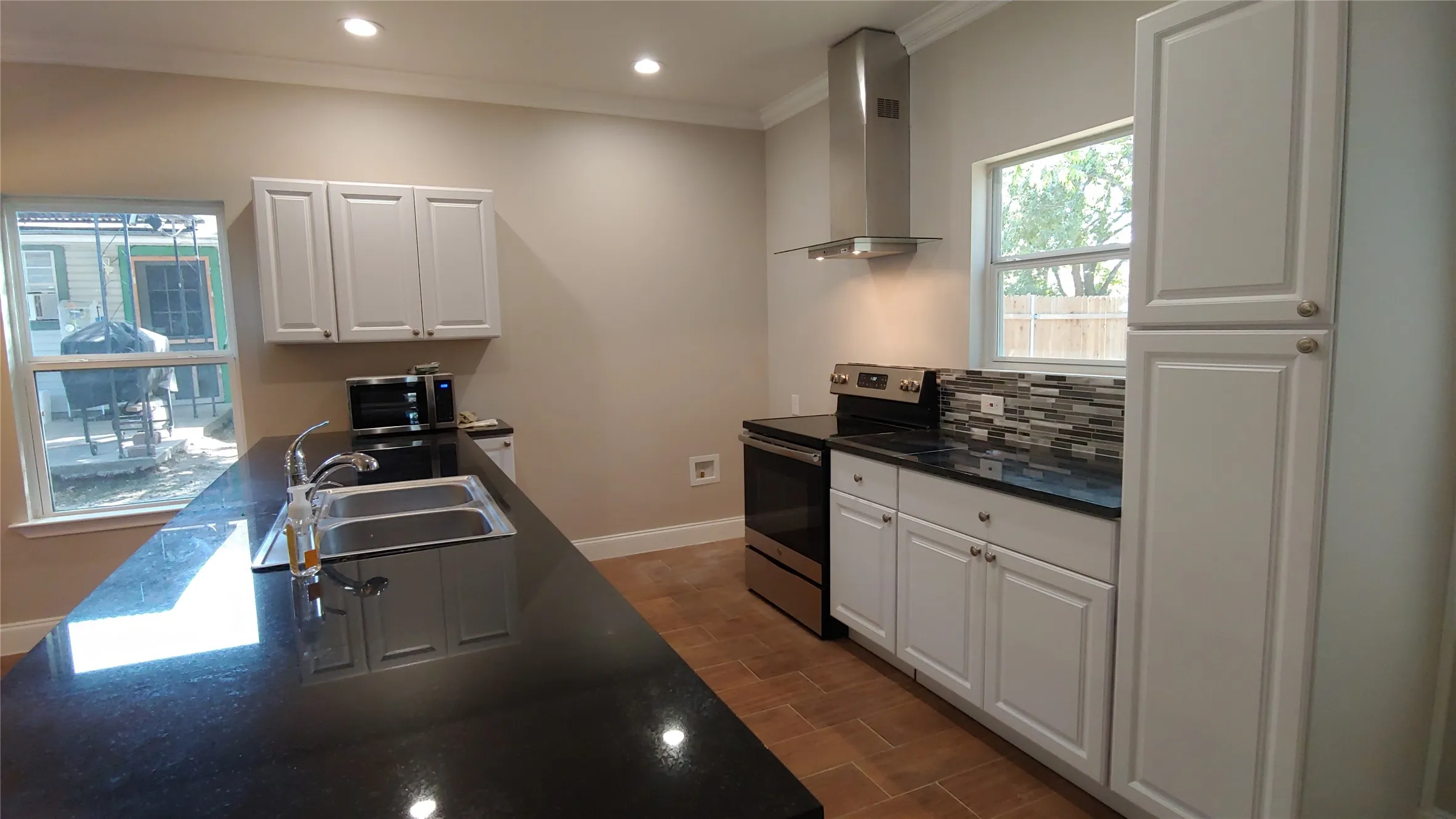 Here is the open space kitchen with a bar that looks into the living area. Notice all of the cabinet space. This is a great kitchen for entertaining guests.