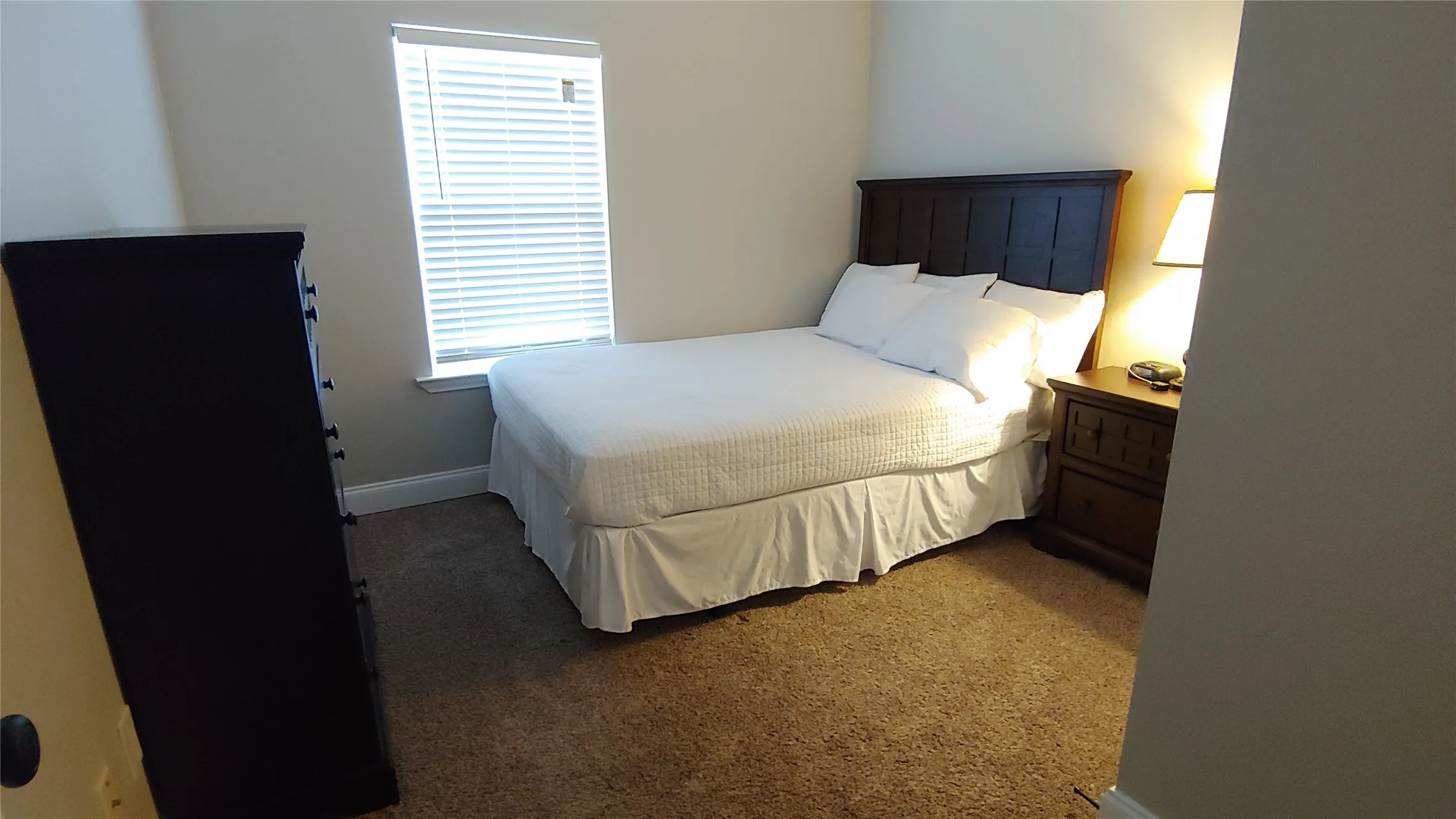 This wonderful bedroom has a lighted ceiling fan to help keep you cool in summer months.