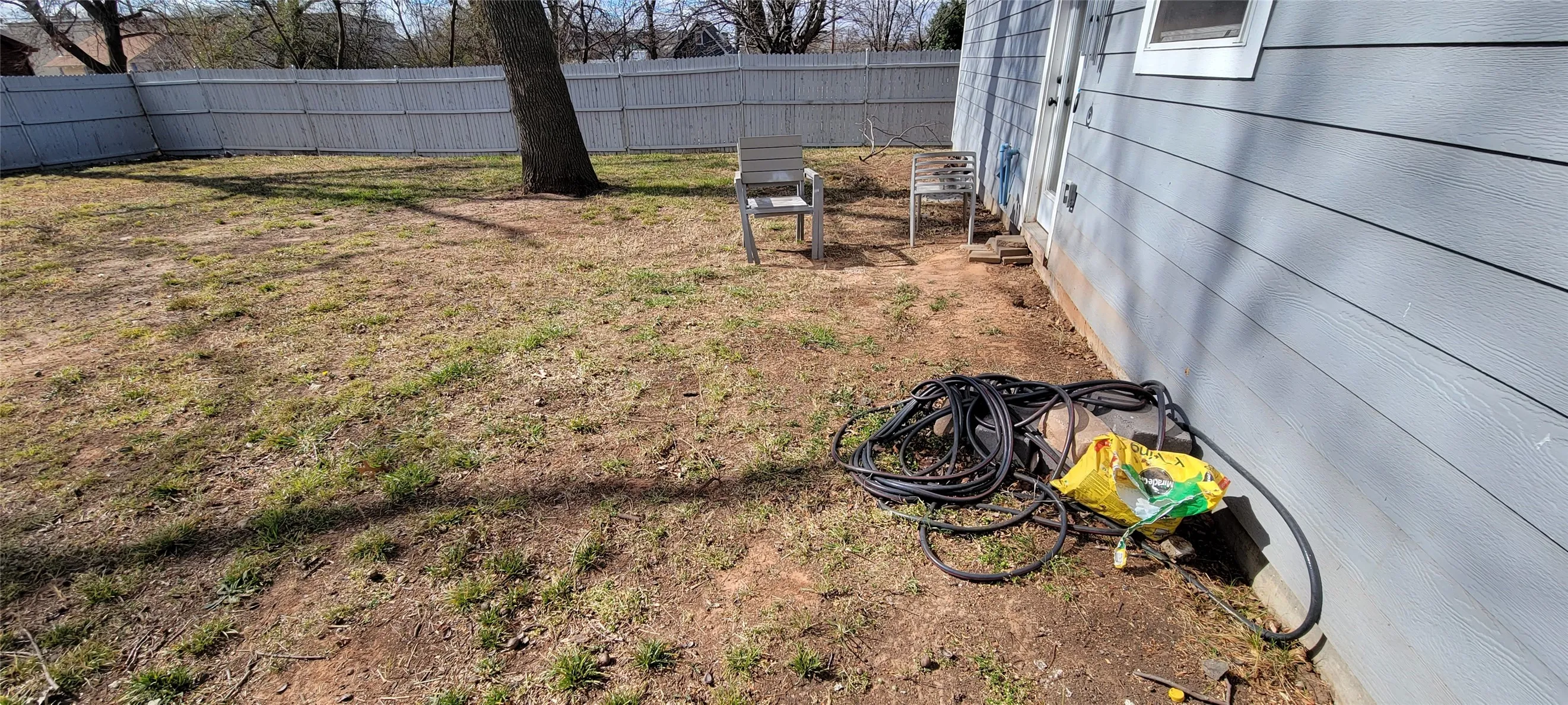 Another view of the yard. Notice the mature tree.