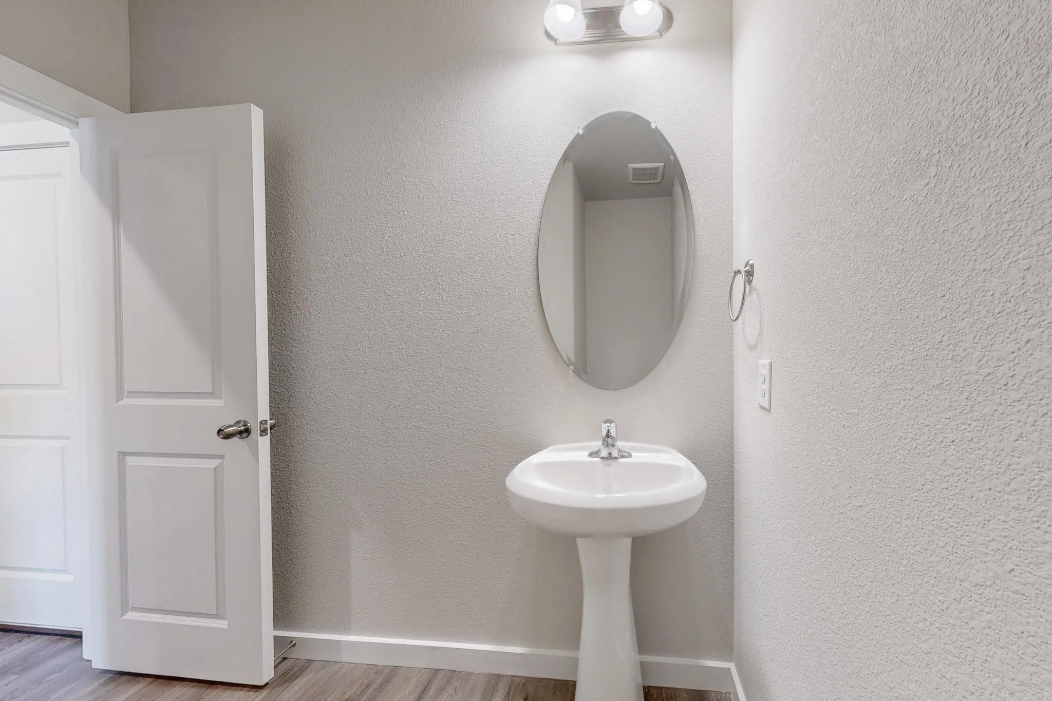 Bathroom with baseboards and light wood finished floors