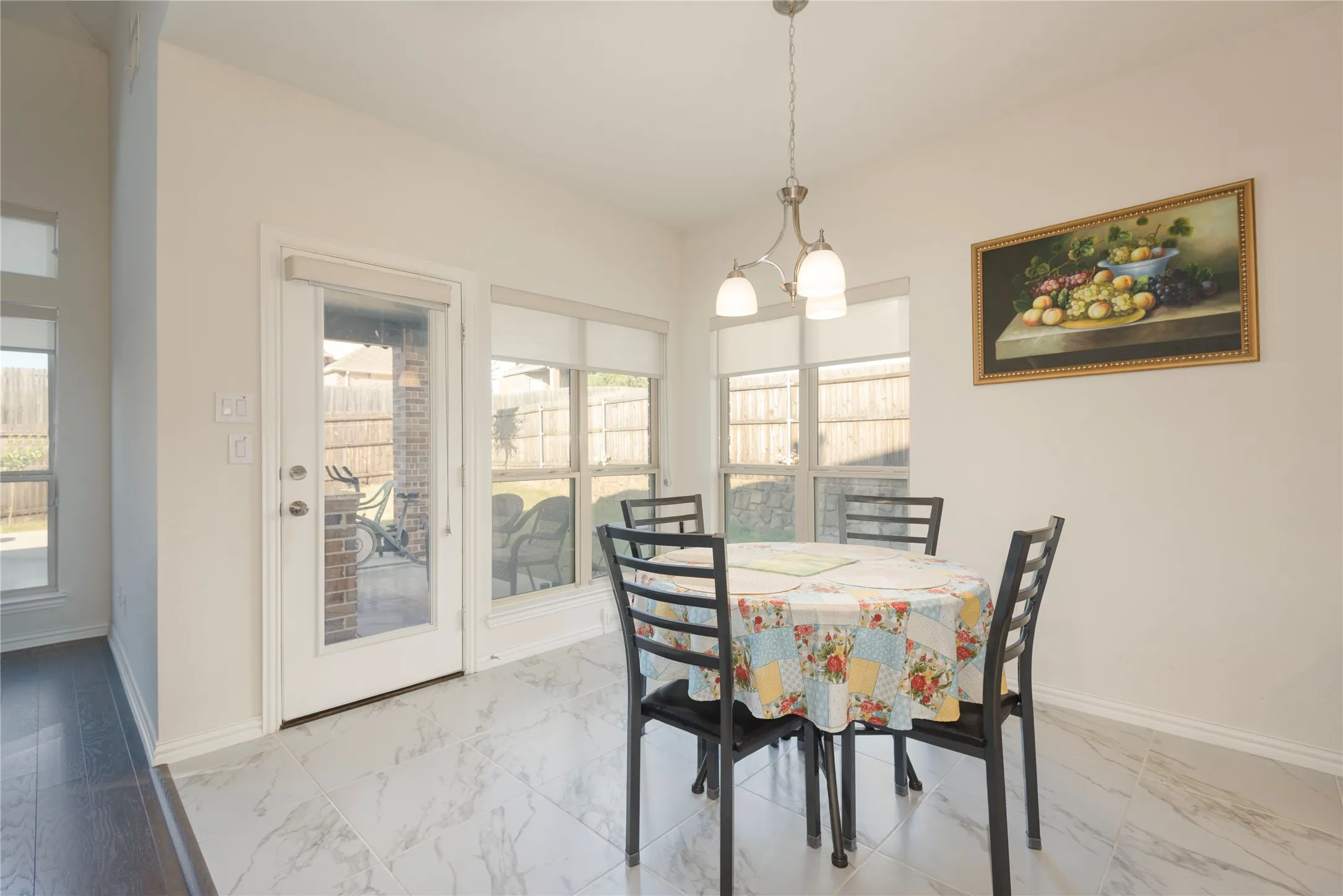 Dining area featuring white marble-look tile flooring
