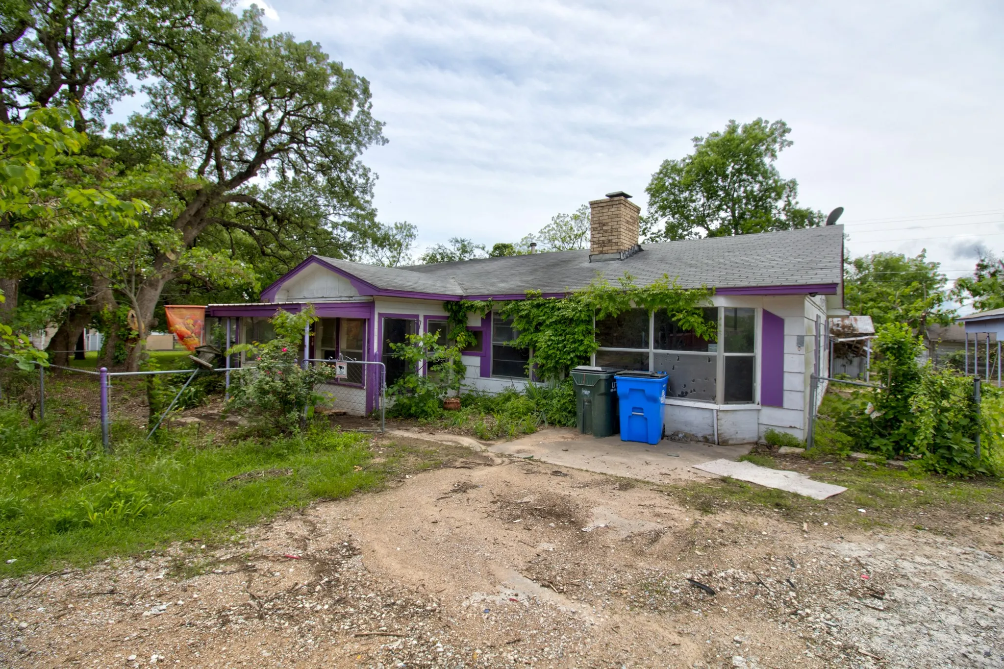 Single-story residence featuring a covered front porch and a brick chimney