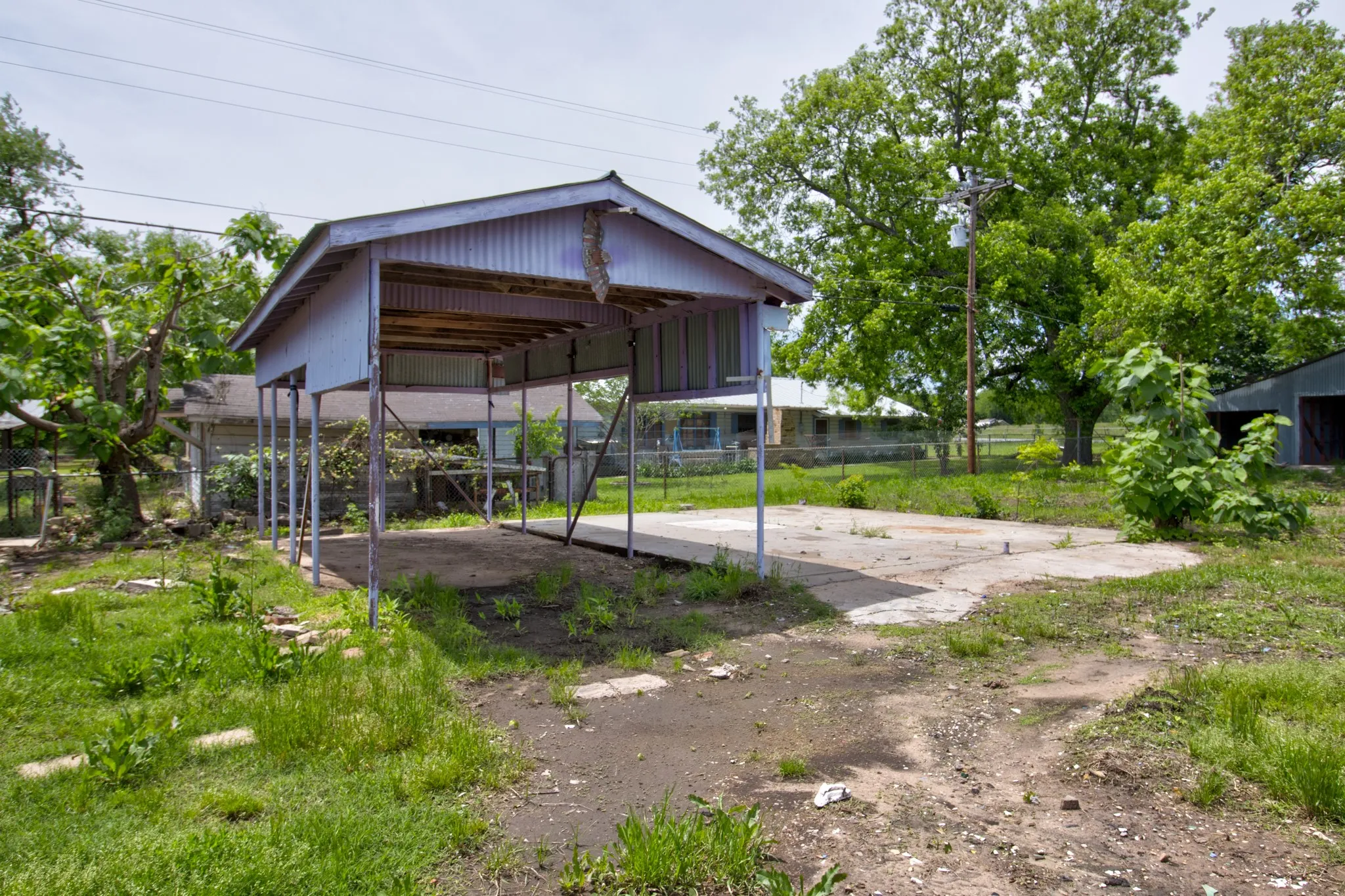 Freestanding metal carport structure with a gabled roof and supporting posts