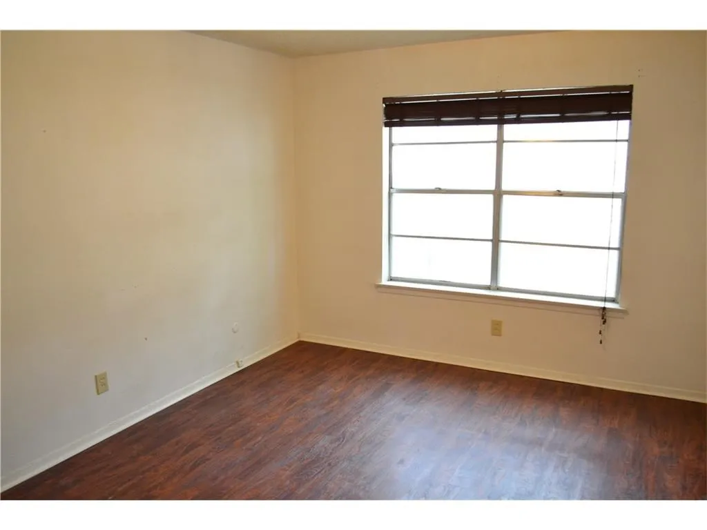 Serene secondary bedroom offering a quiet and restorative energy for guests or family.