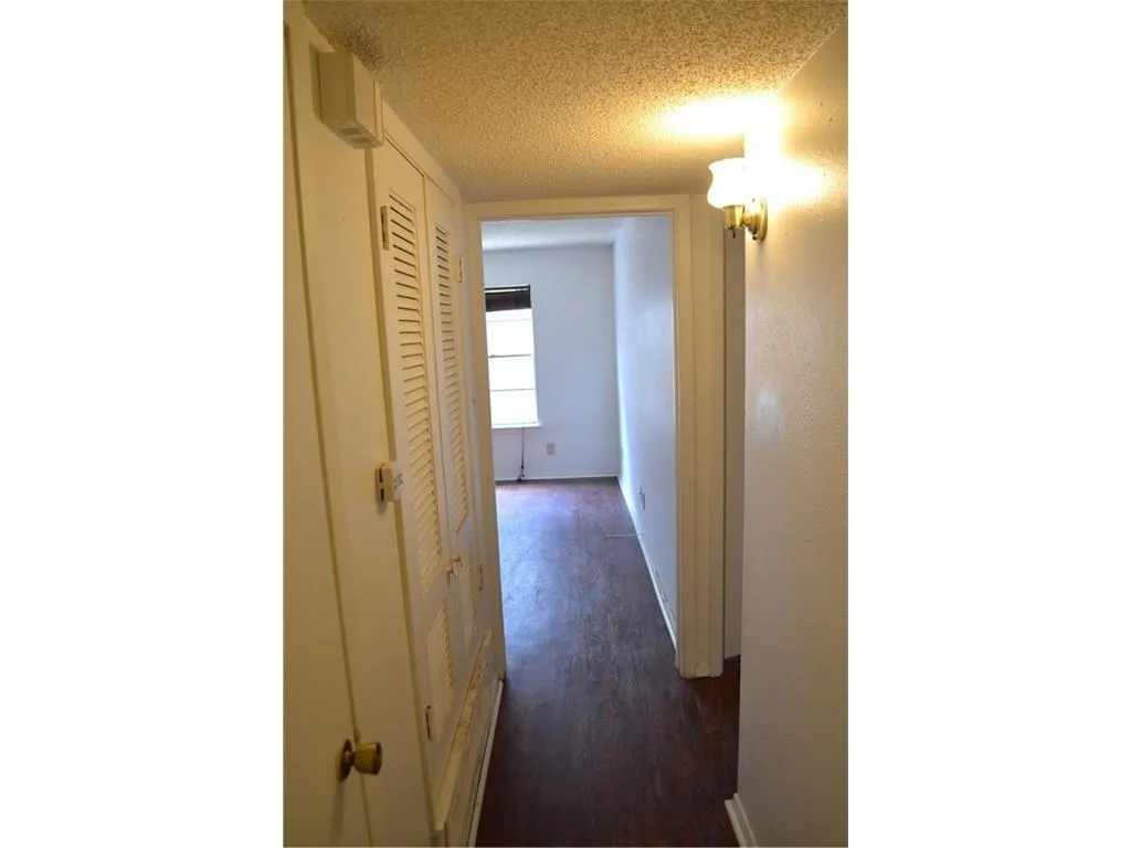 Well-lit hallway providing a smooth and effortless transition between living spaces.