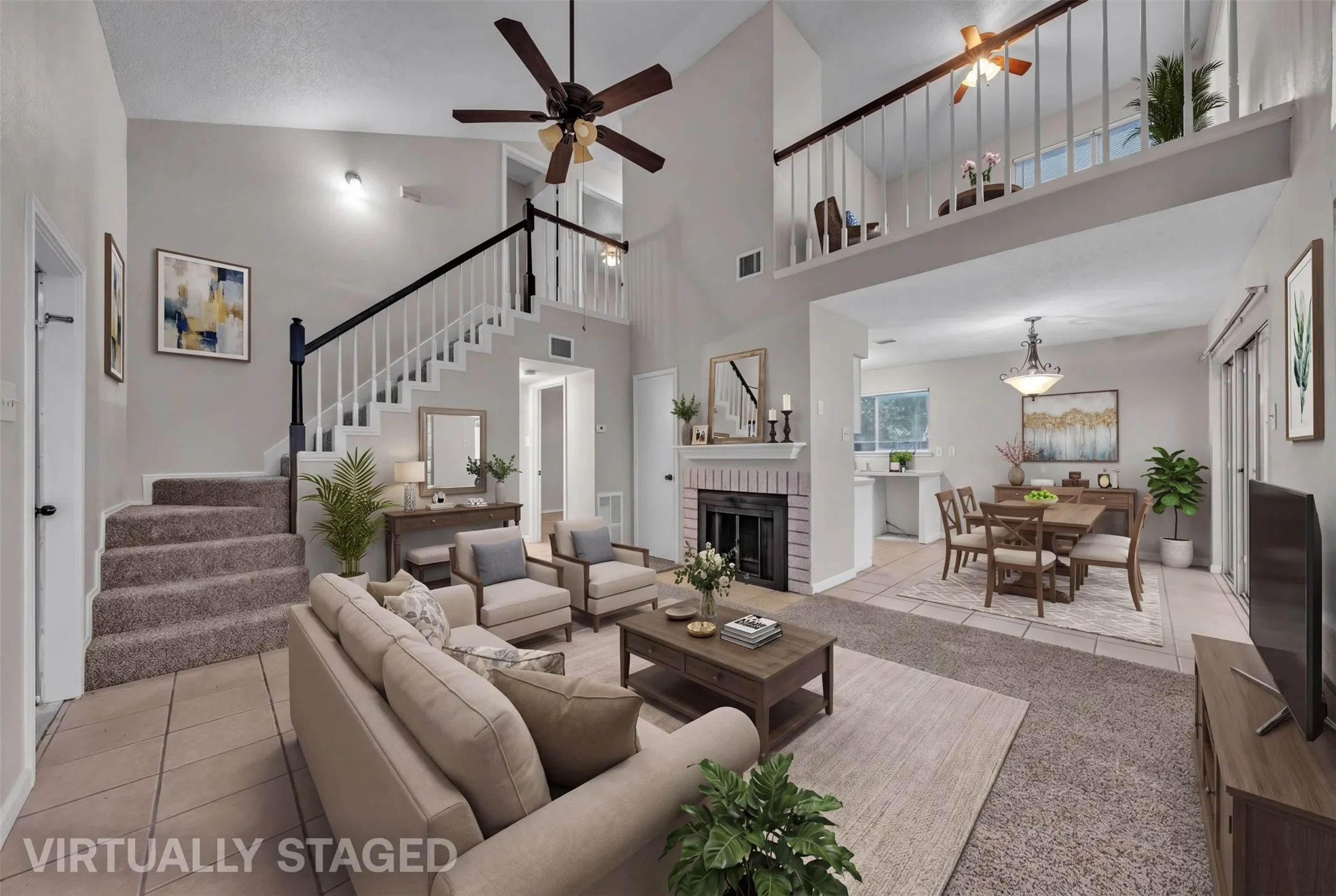Two-story living area featuring a vaulted ceiling with ceiling fans, a brick-surround fireplace, a carpeted staircase with a white and black railing, and tile flooring