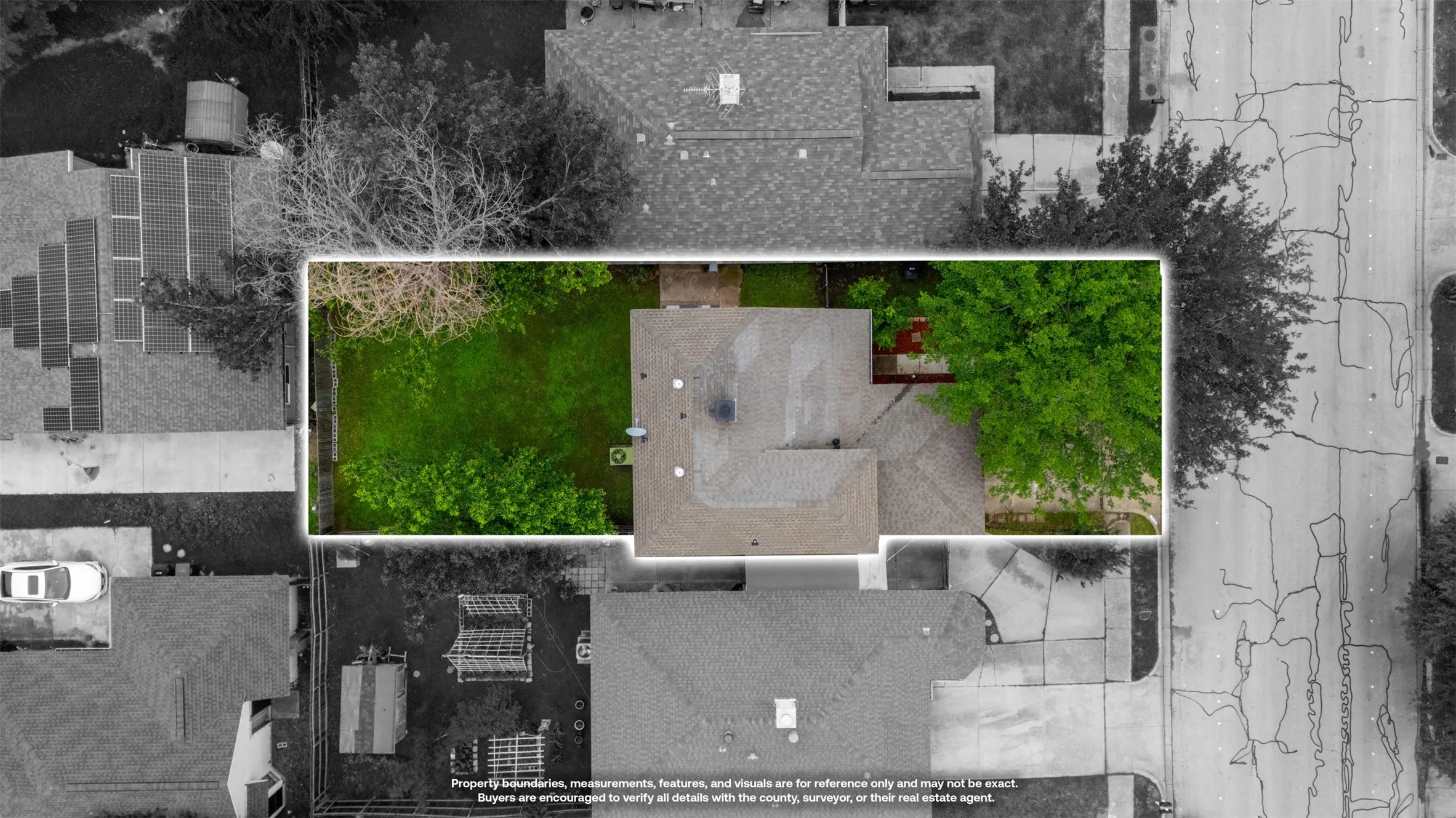 Aerial view showcasing the property's footprint with a gabled roofline and an expansive green lawn
