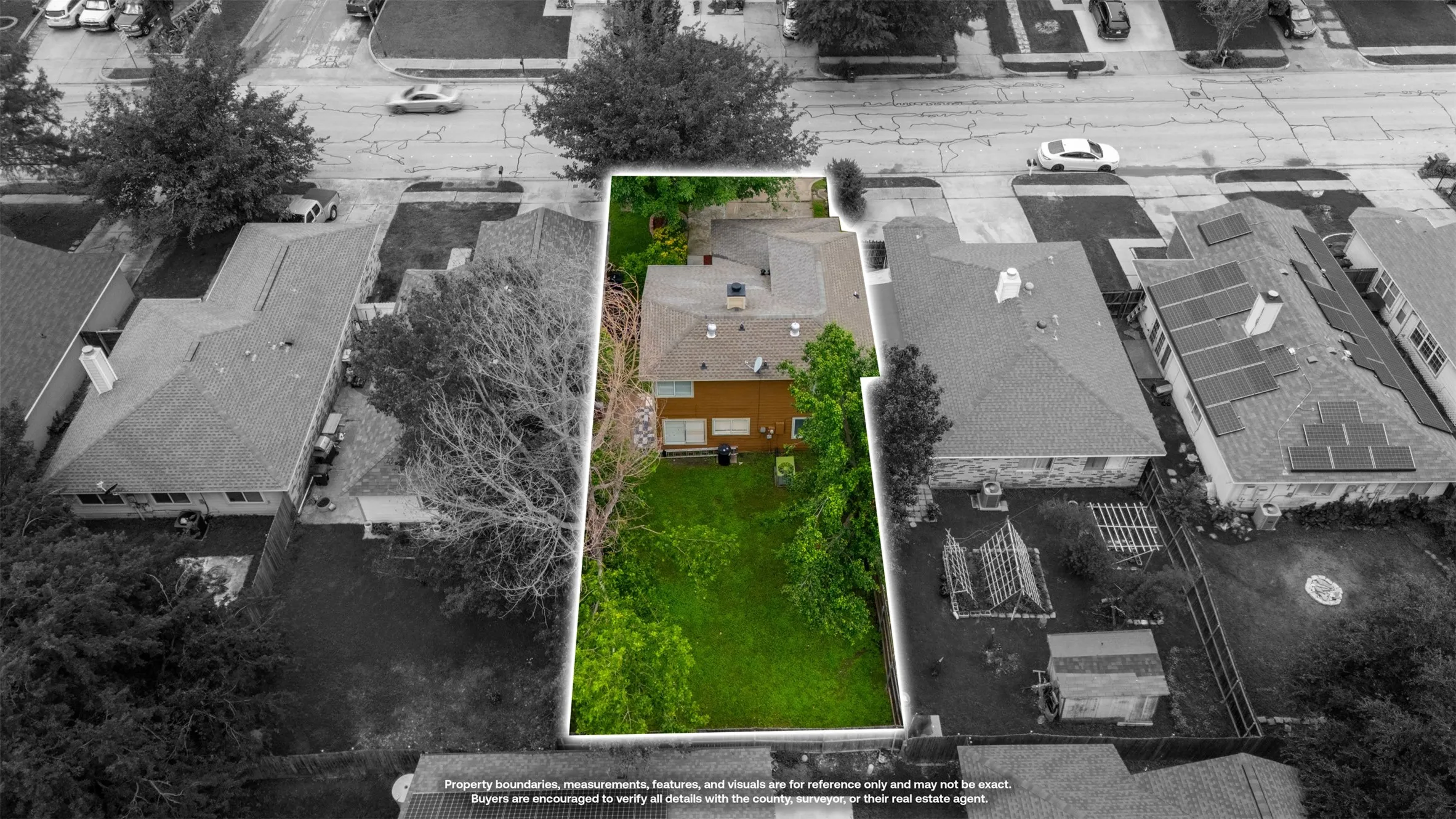Aerial perspective of a property featuring a brown two-story residence with a pitched roof and a spacious green lawn