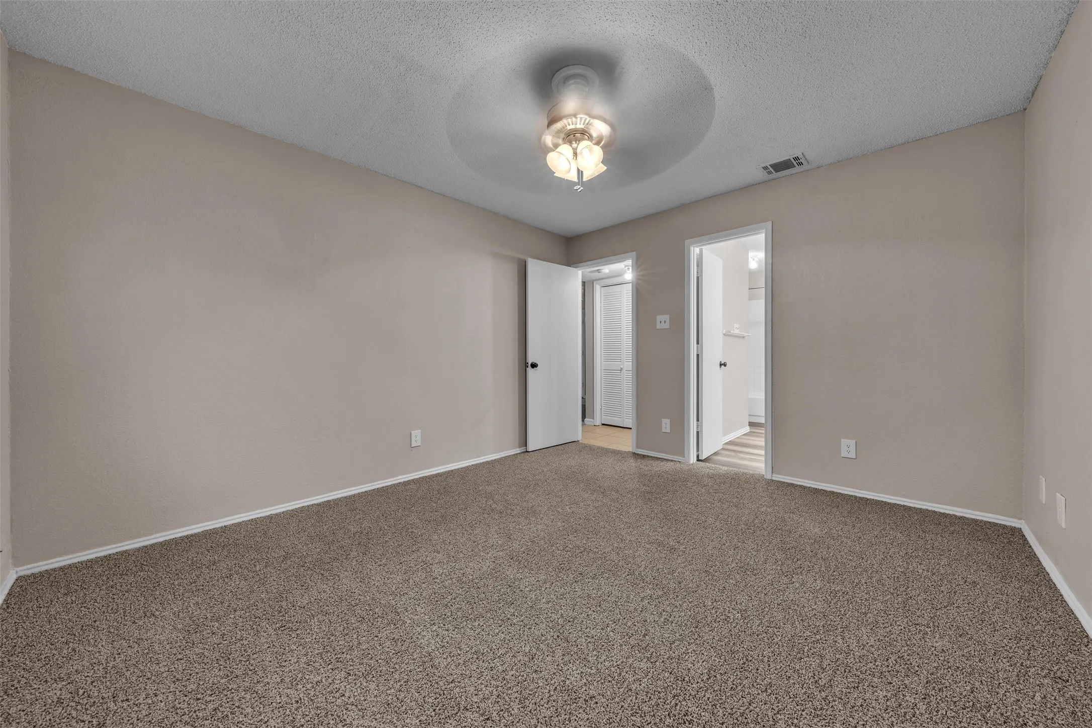 Carpeted interior room with neutral-toned walls