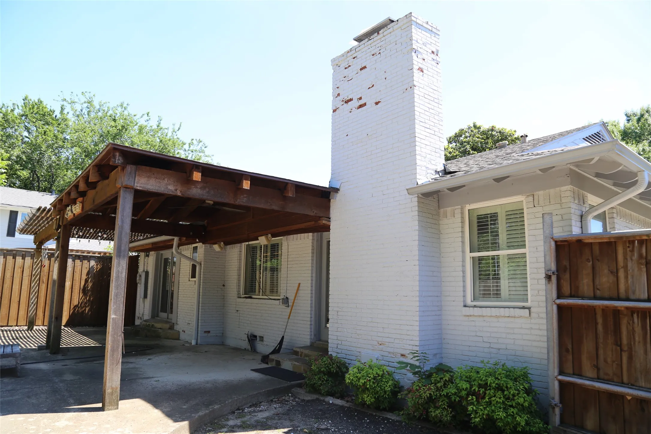 Expansive covered patio featuring a wood pergola structure