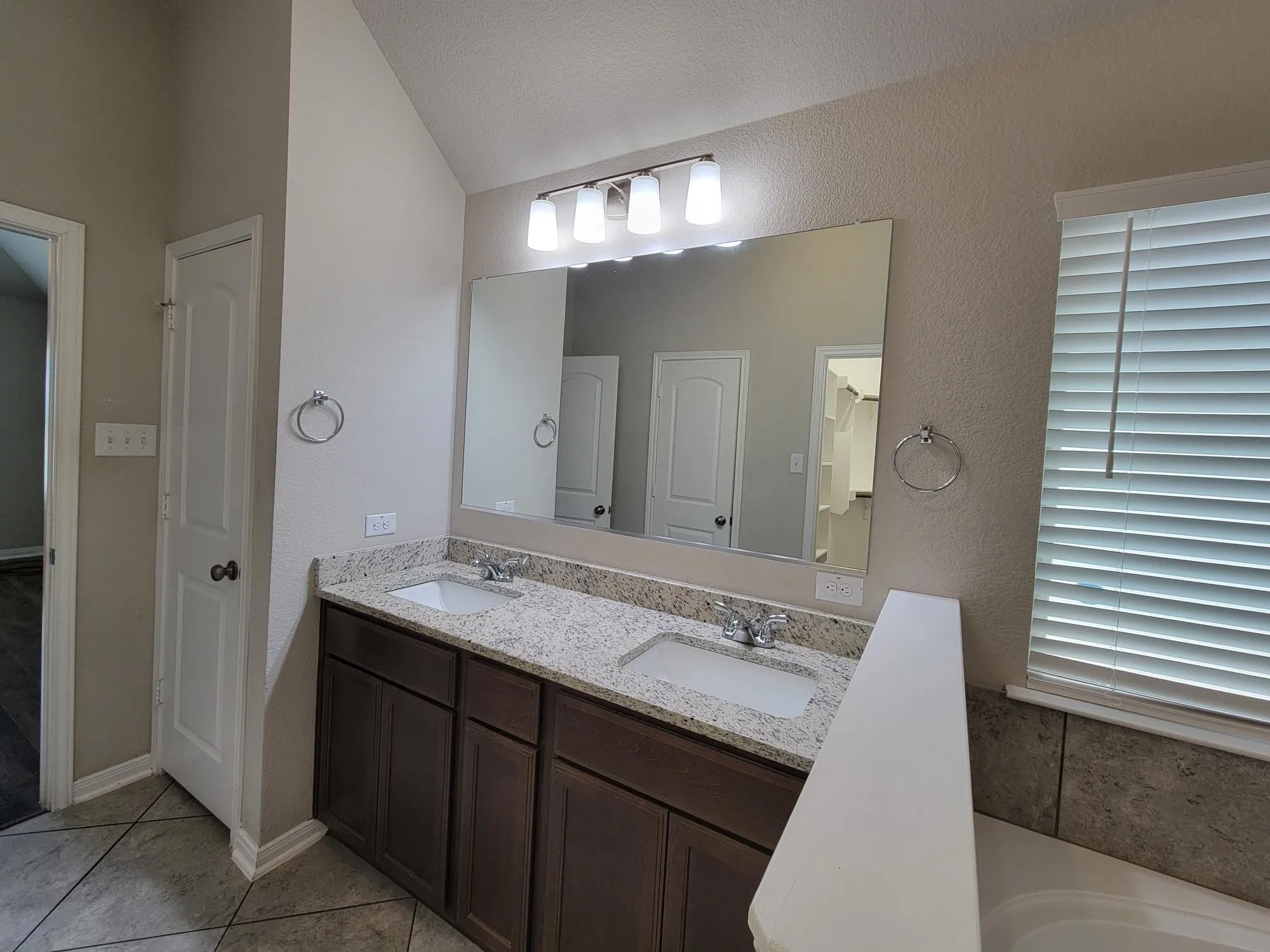 Double vanity with granite-style countertop and integrated sinks