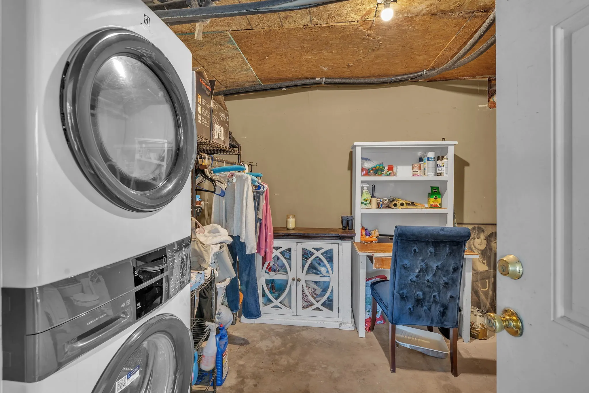 Laundry/ utility area/ bathroom with washer/dryer setup and extra room for storage.