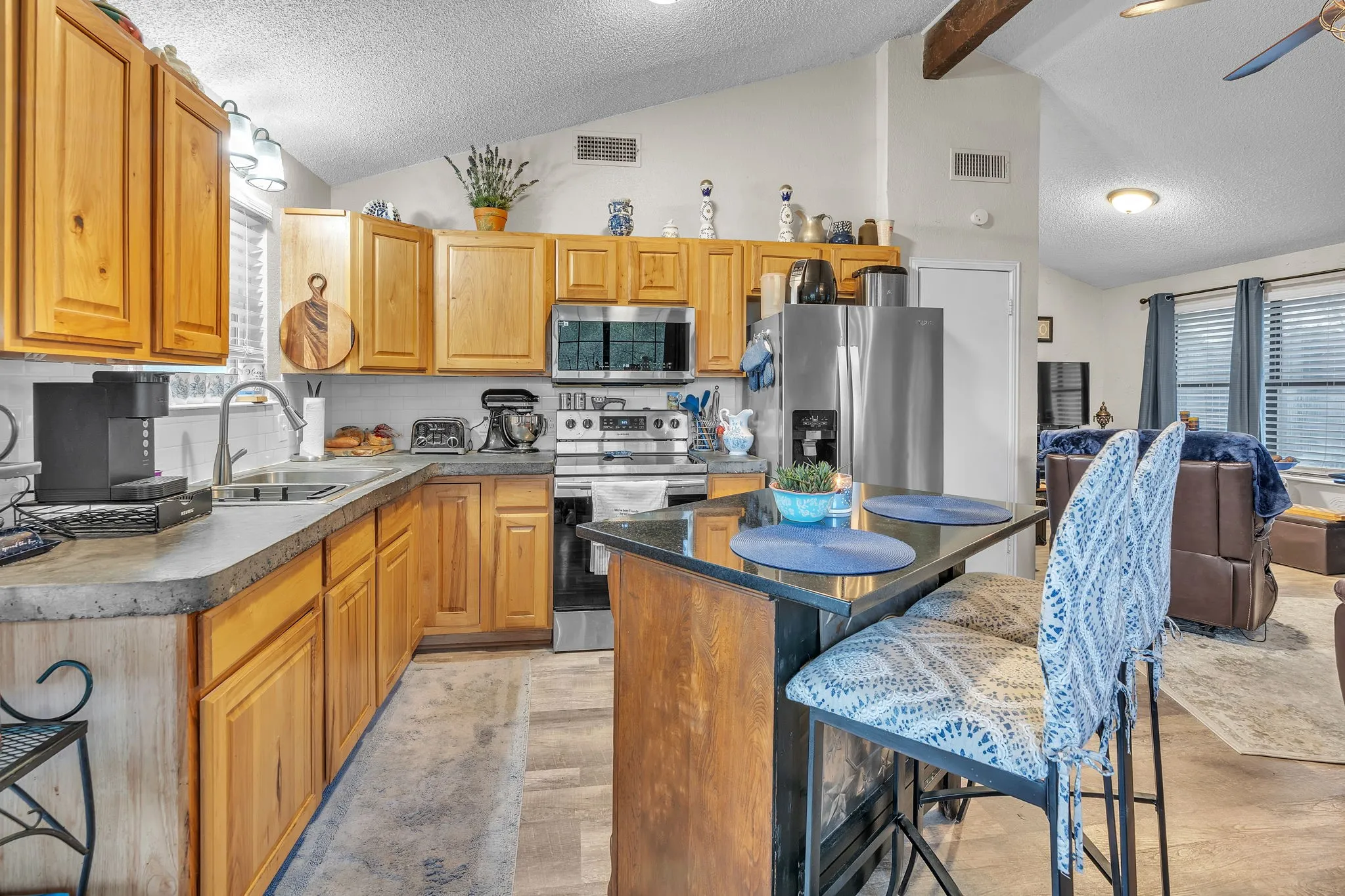 Another kitchen angle showing counter space and casual seating options. Great for everyday living.
