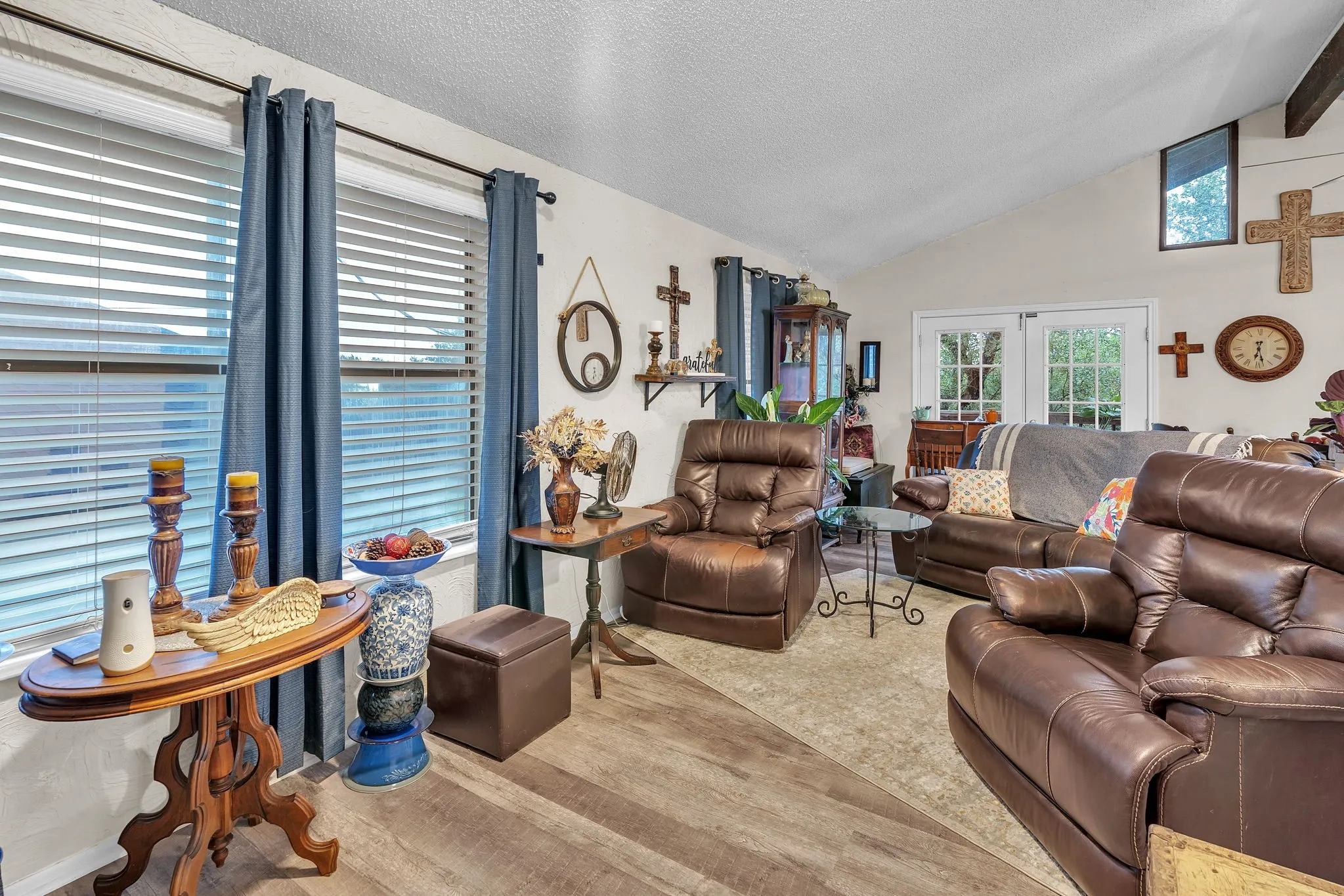 Alternate living room angle highlighting windows and seating space. Warm and inviting feel.
