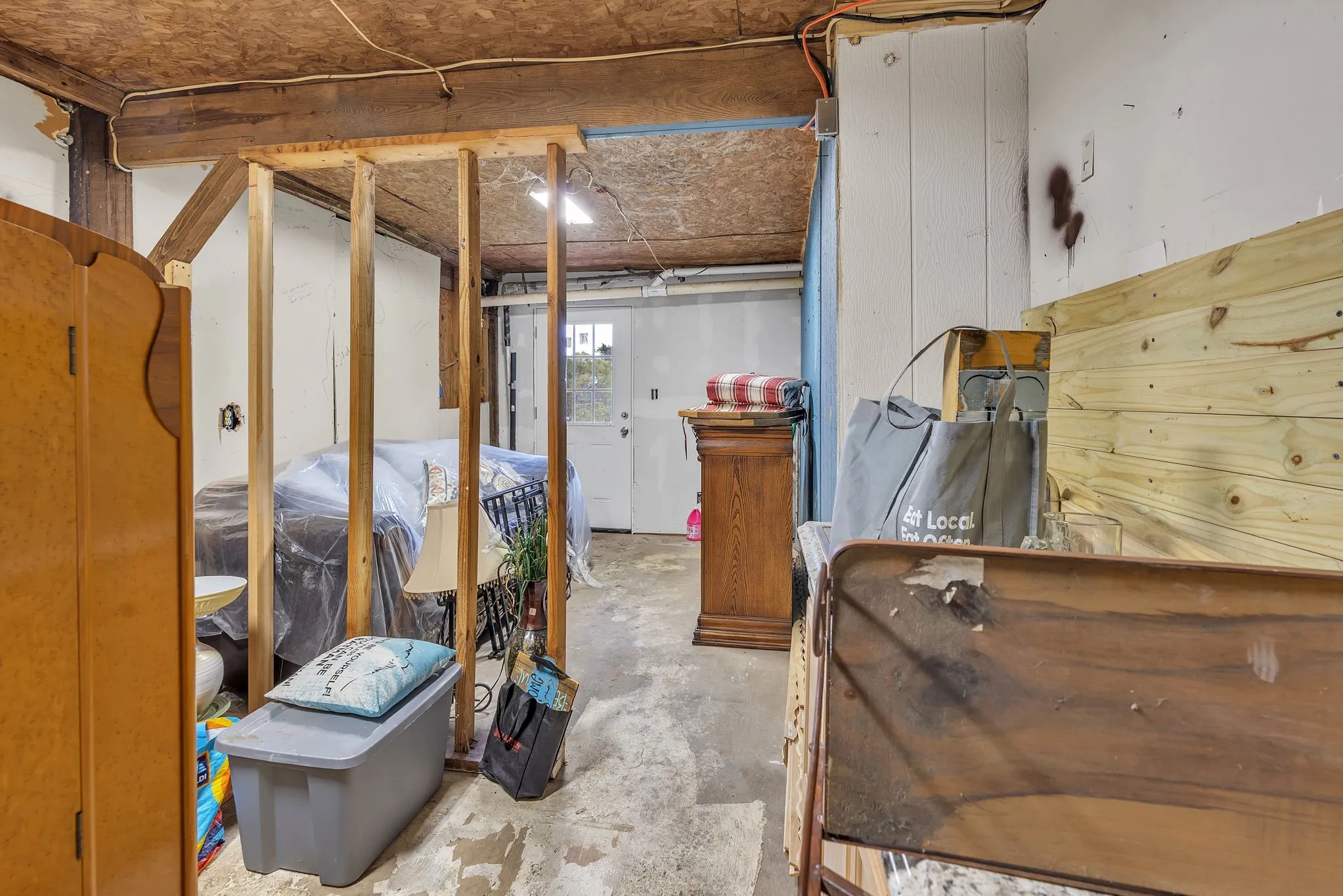 Unfinished lower-level space offering workshop or storage potential. Functional and versatile.