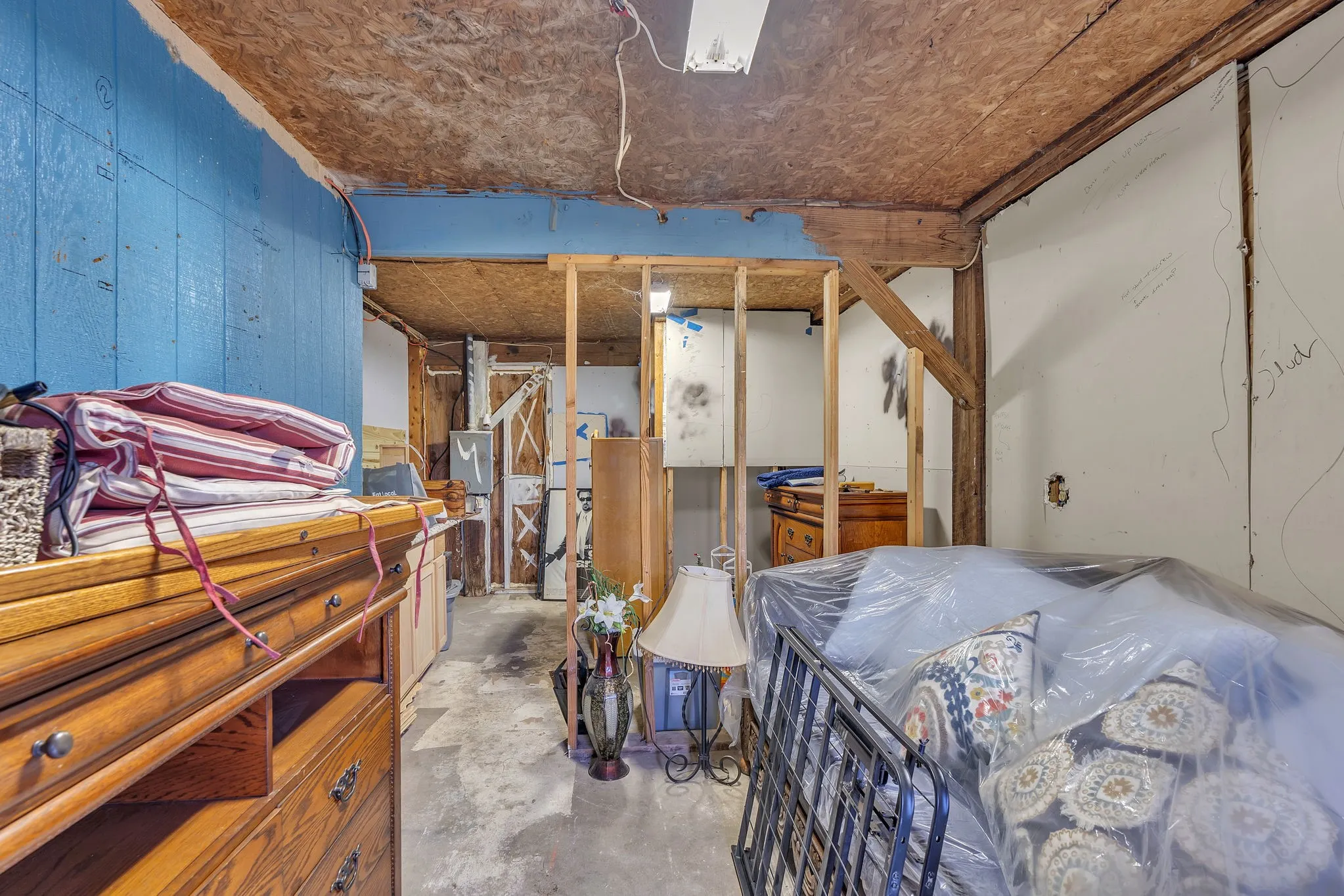 Unfinished lower-level space offering workshop or storage potential. Functional and versatile.
