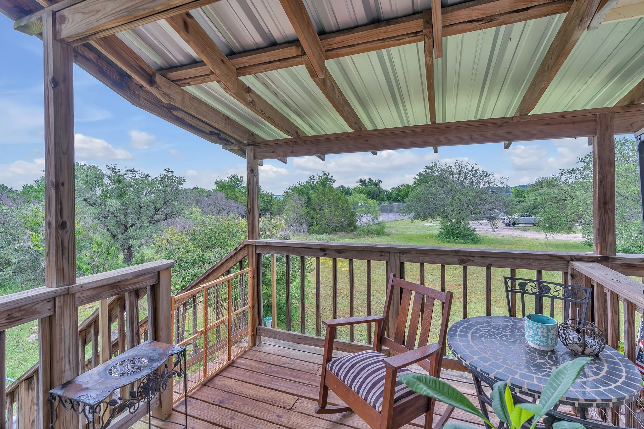 Deck angle highlighting open views and surrounding greenery. A calm and scenic outdoor retreat.