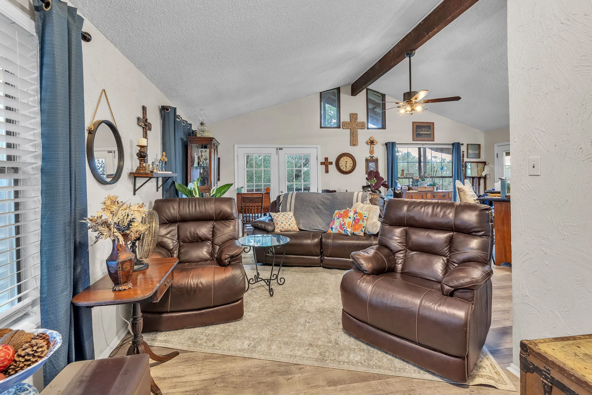 Bright and open living room with vaulted ceilings and great natural light. A comfortable central gathering space.
