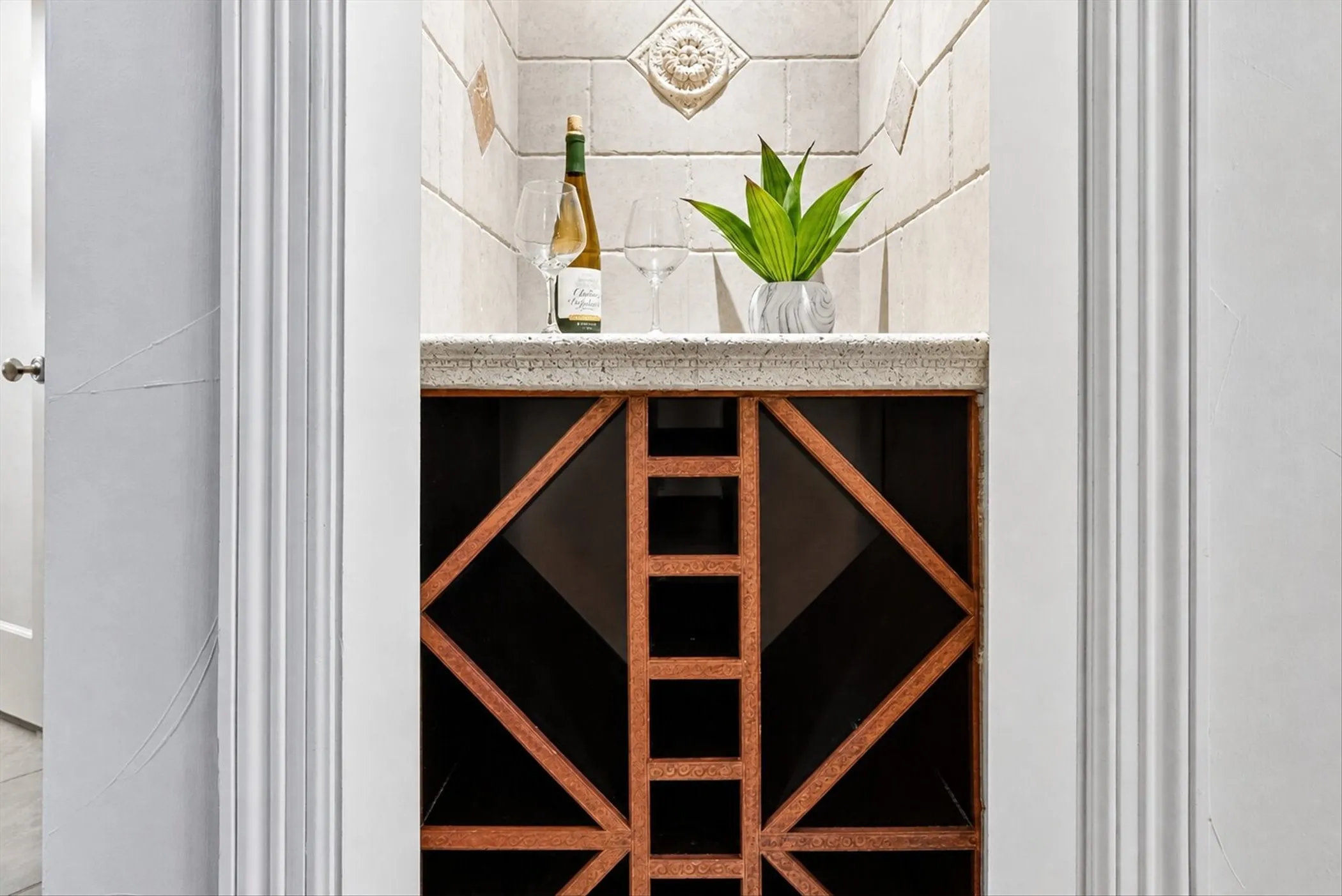 Built-in wine storage niche featuring a stone countertop