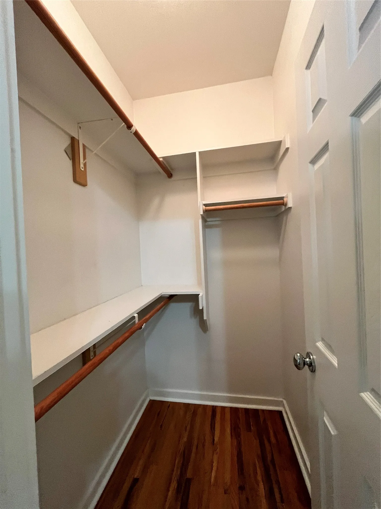 Walk-in closet with wrap-around shelving.