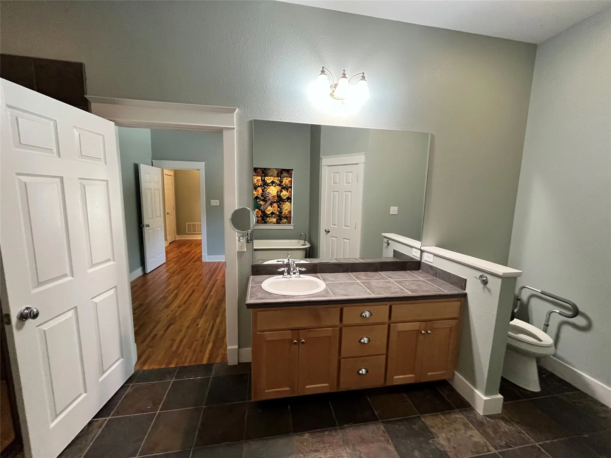 Bathroom vanity with plenty of counter space and large mirror.