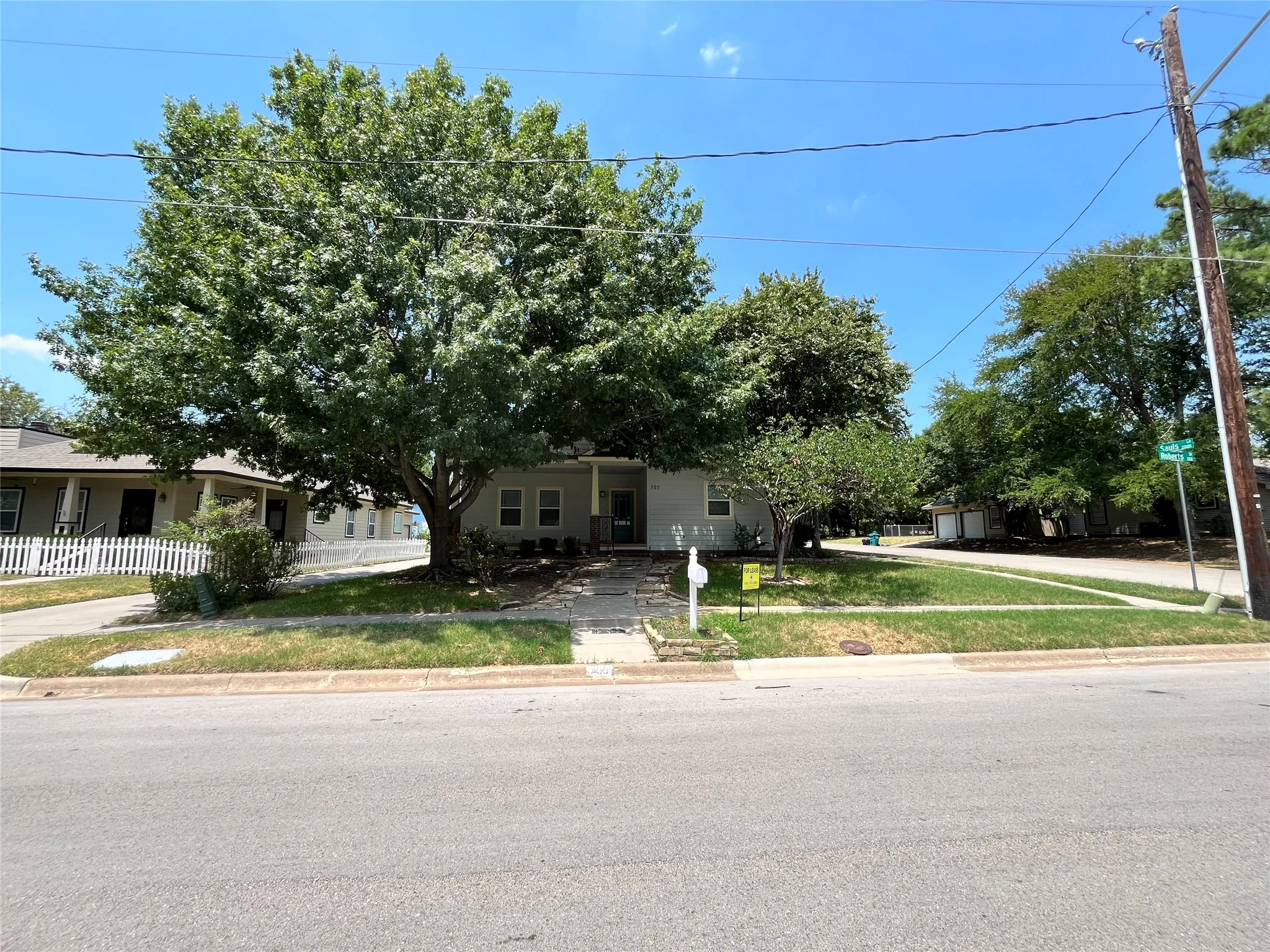 Street view of the property highlighting the large corner lot.