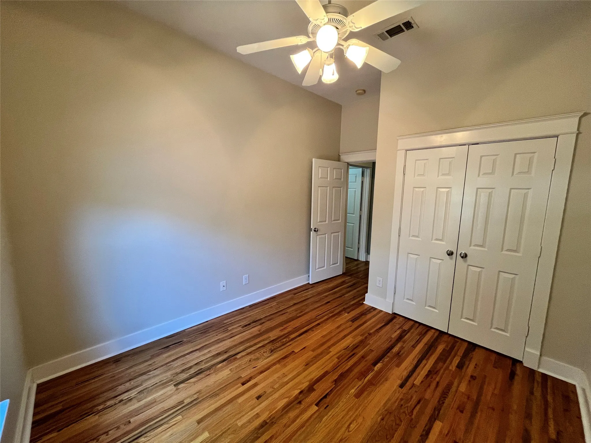 Third bedroom featuring great natural light and wood flooring.