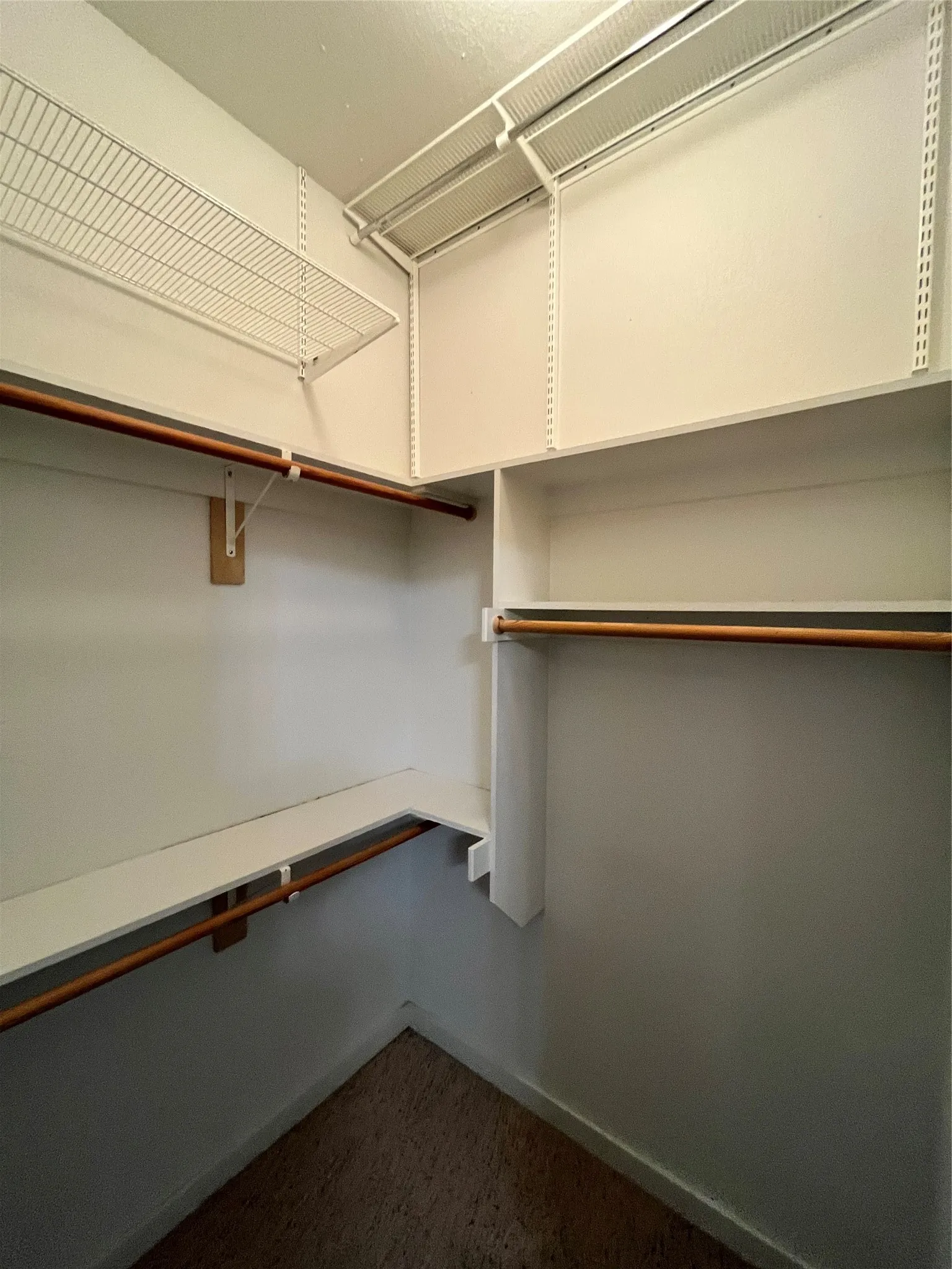 Walk-in closet with multiple levels of hanging space.