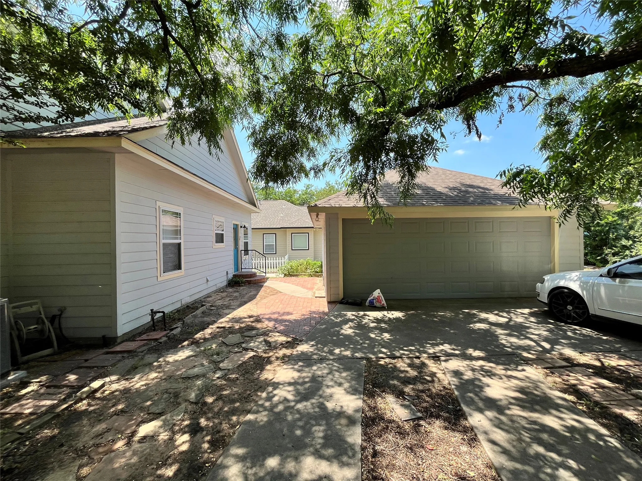 Side view of the property showing the garage and driveway.