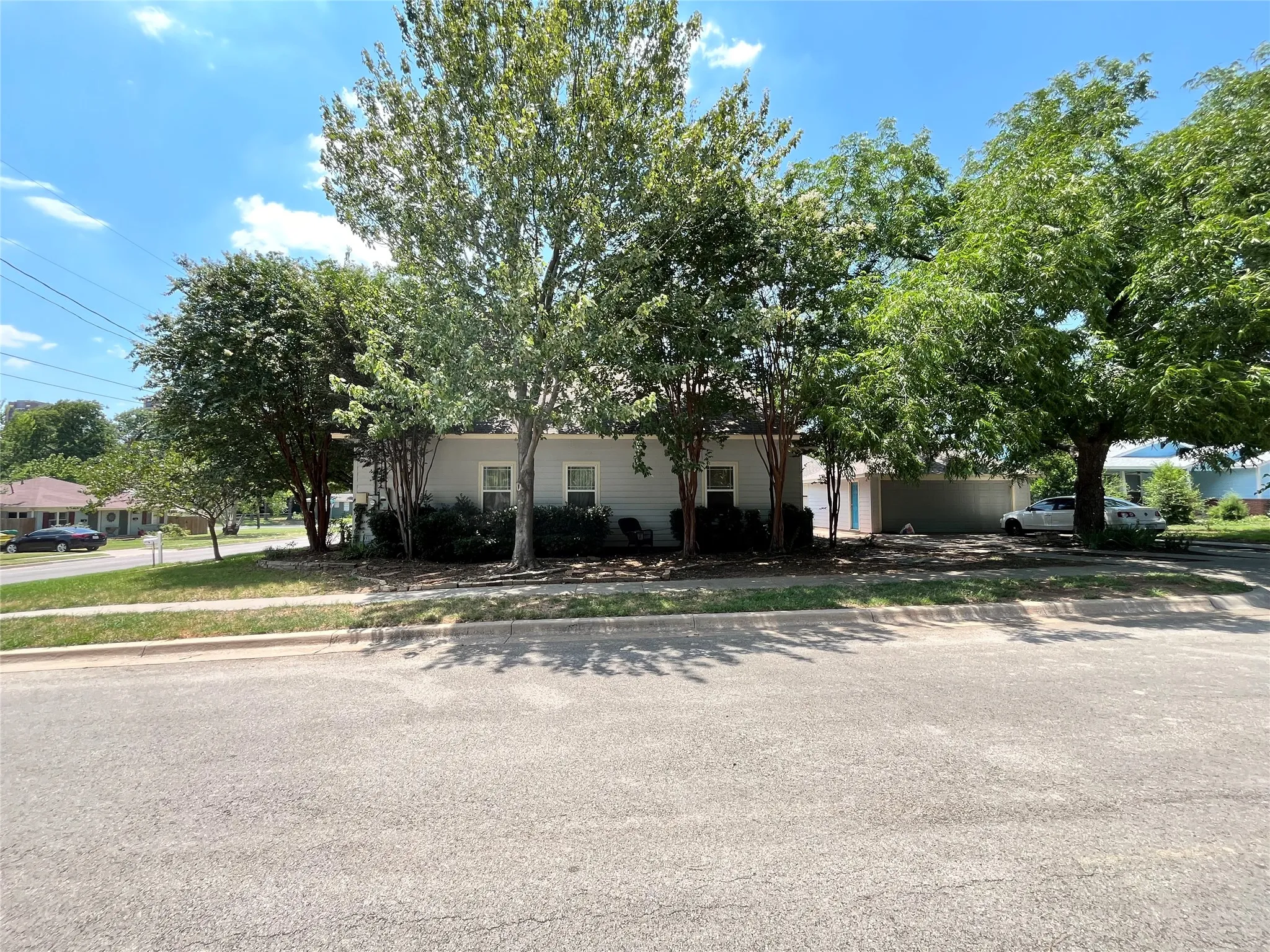 Full view of the home nestled among trees.