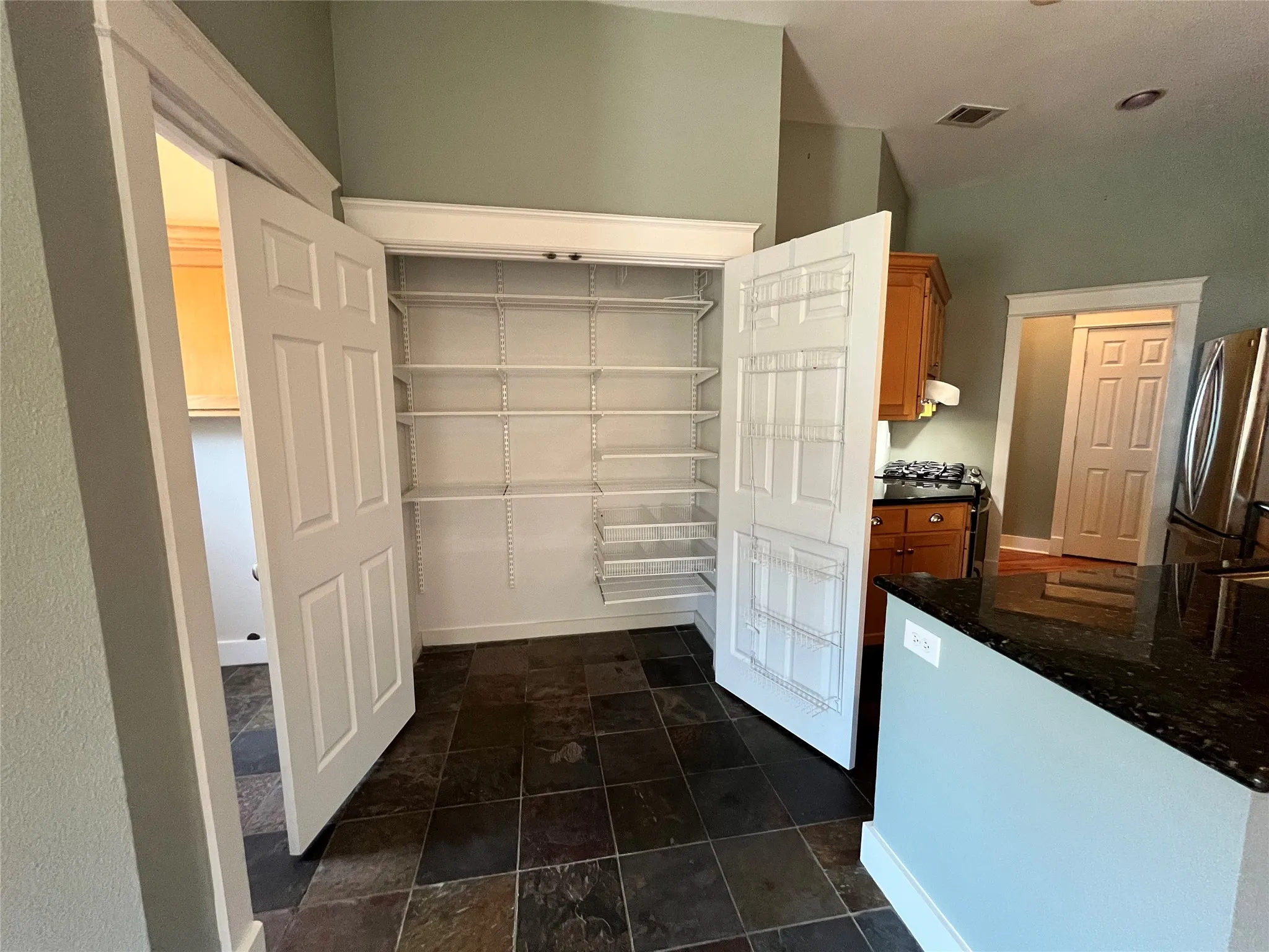 Large walk-in pantry or storage closet with built-in shelving.