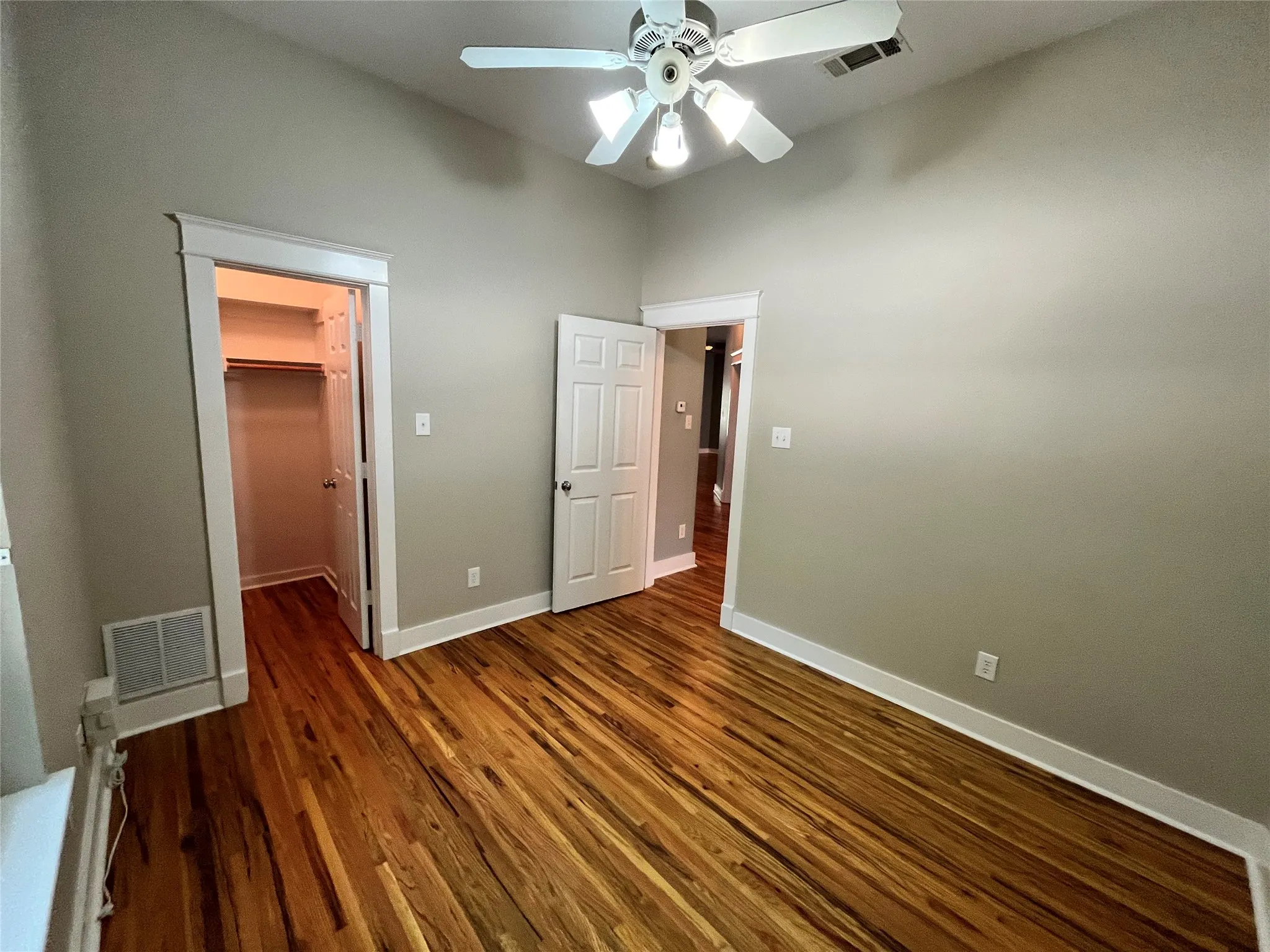 View of the bedroom entryway and continued hardwood floors.
