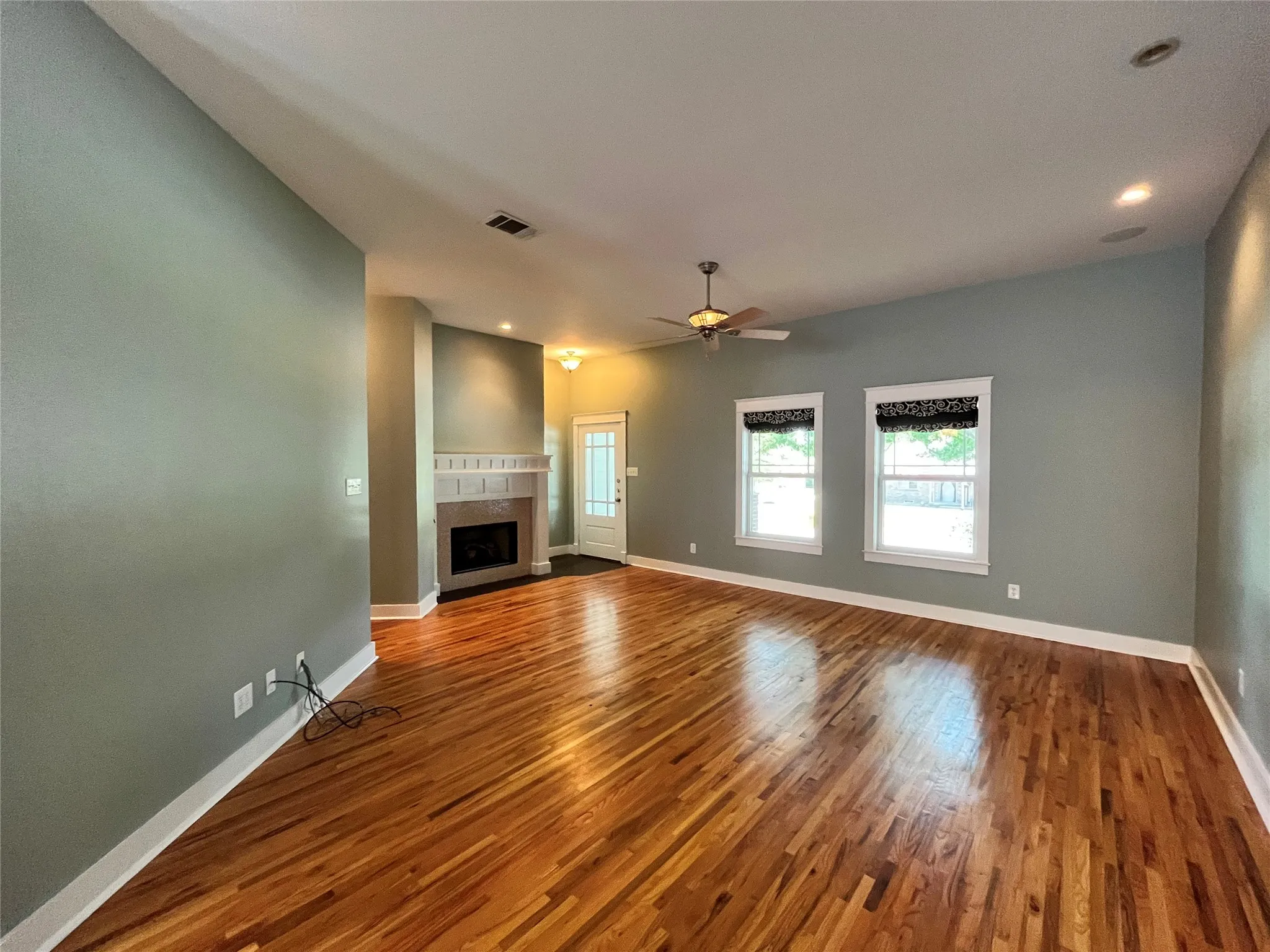 Bright living room featuring a cozy fireplace and plenty of natural light.