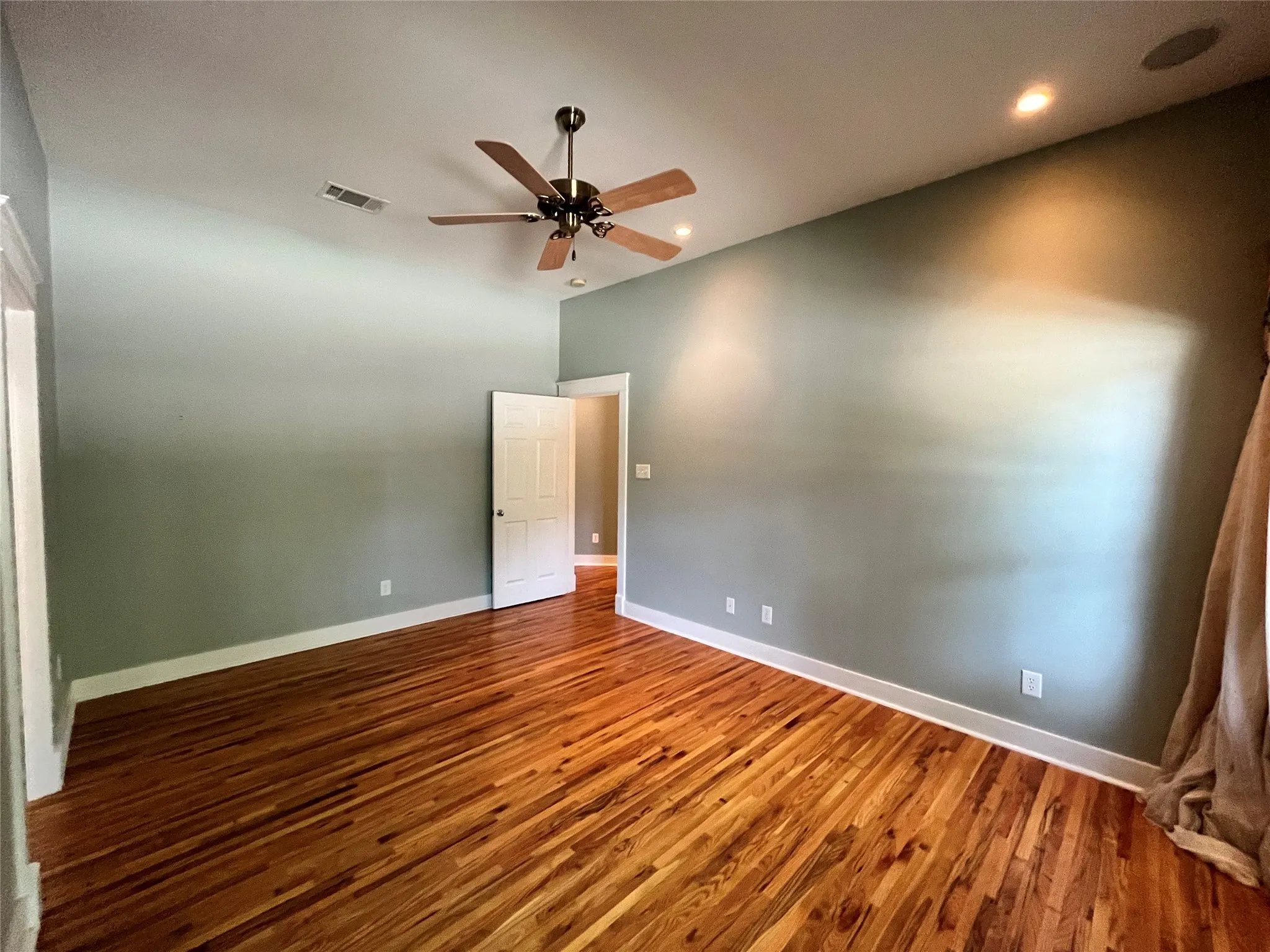 Another angle of the main bedroom showing the generous size.