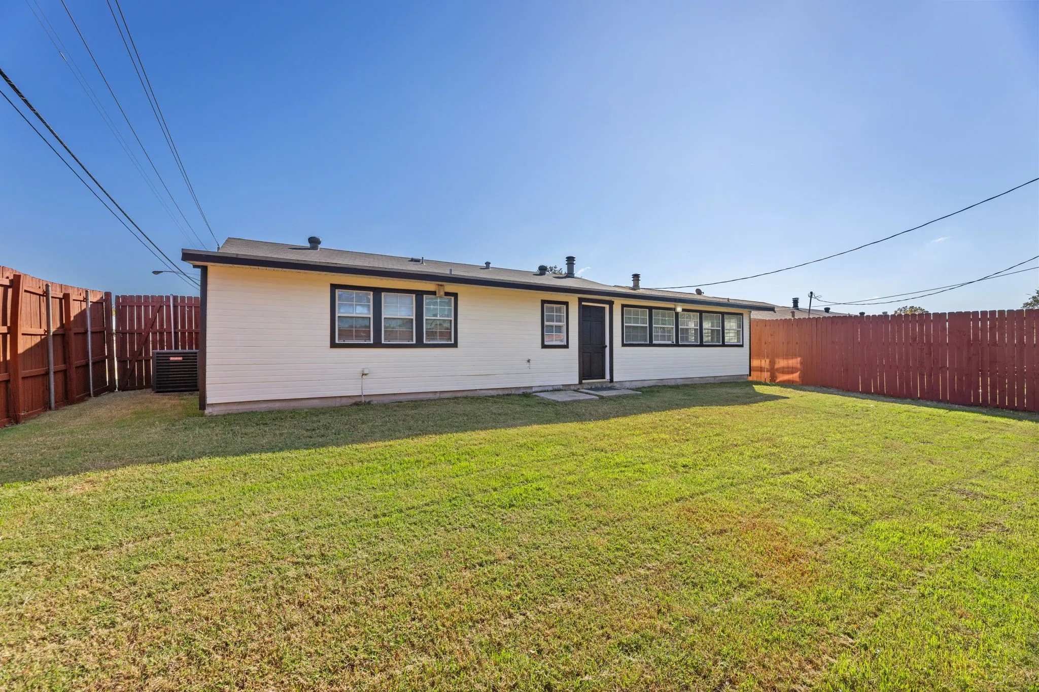 Back of house featuring a fenced backyard and a patio