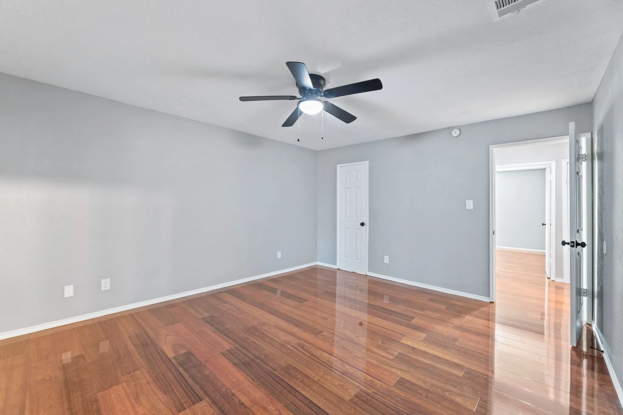 Another view of 2nd bedroom with wood finished floors and ceiling fan