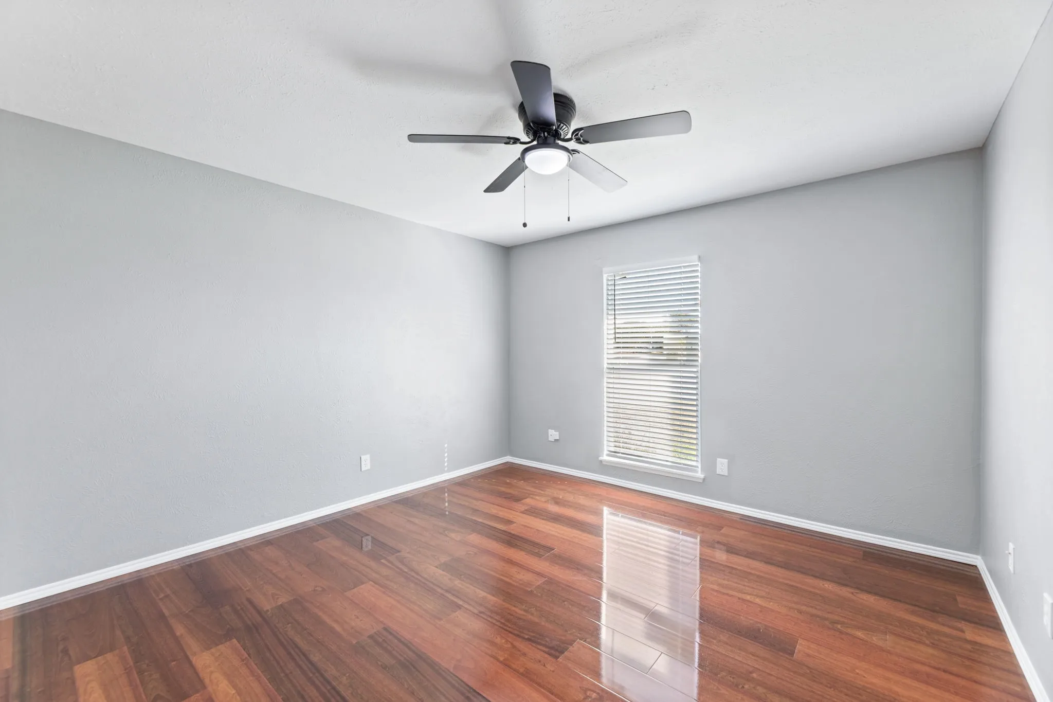 Bedroom with wood finished floors and ceiling fan