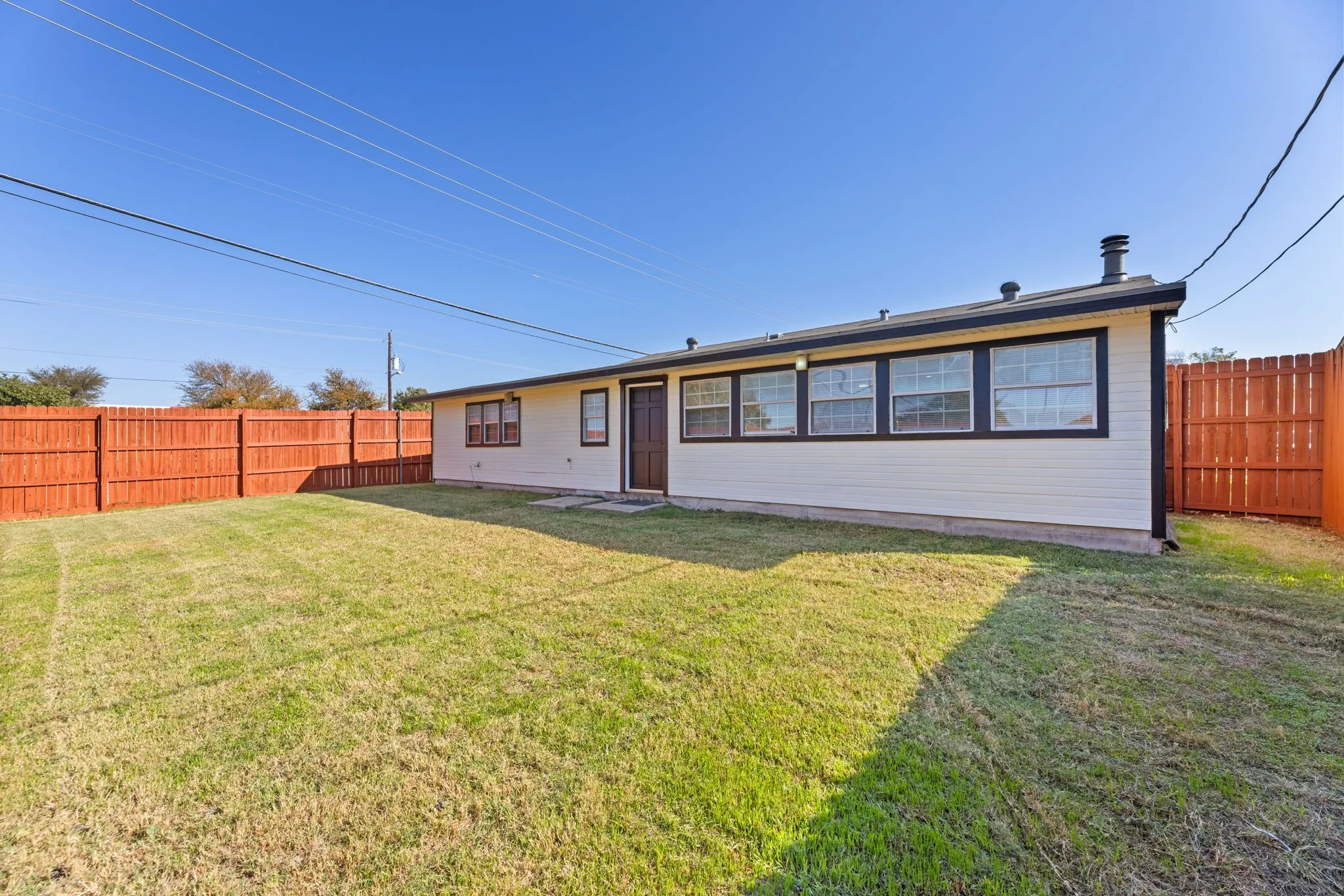 Back of house featuring a fenced backyard