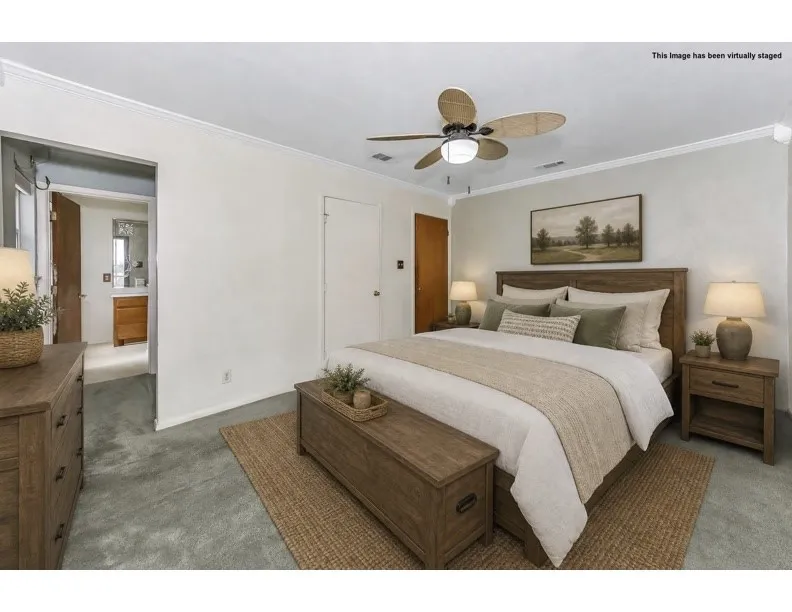Bedroom featuring light gray carpet flooring and white crown molding