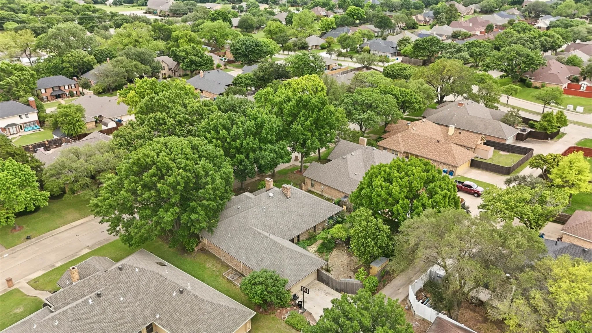 Aerial perspective showcasing a residential area with mature trees