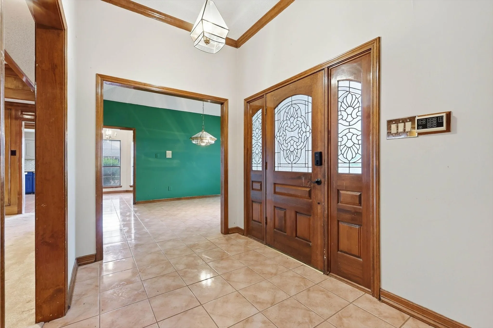 Warm wood-finish double entry doors with decorative leaded glass panels