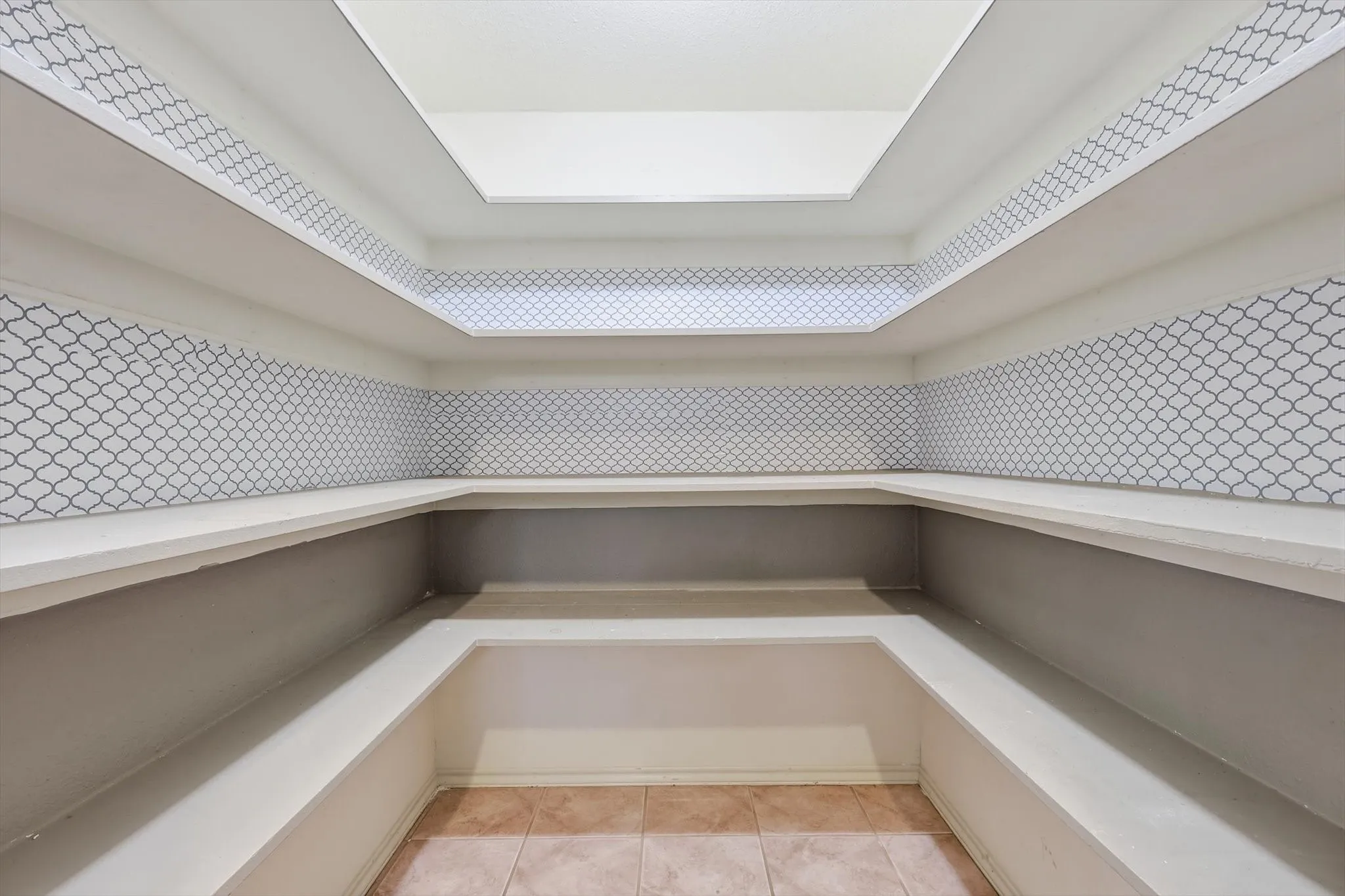 Built-in shelving with gray arabesque pattern detailing