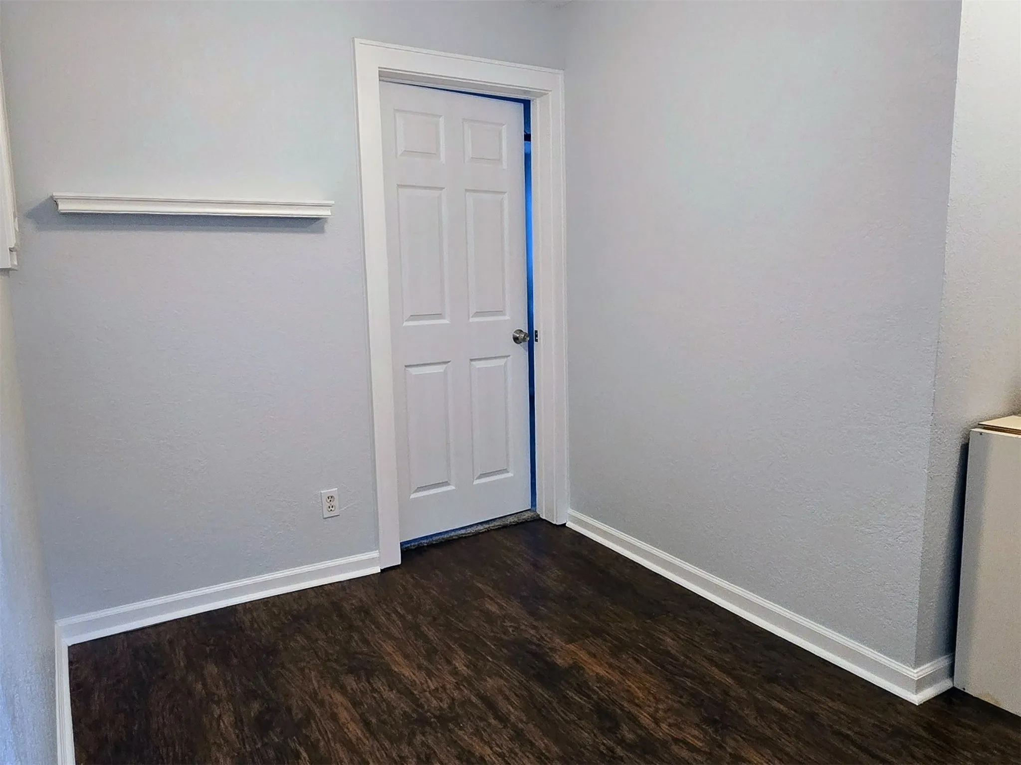 Empty room with dark hardwood / wood-style flooring