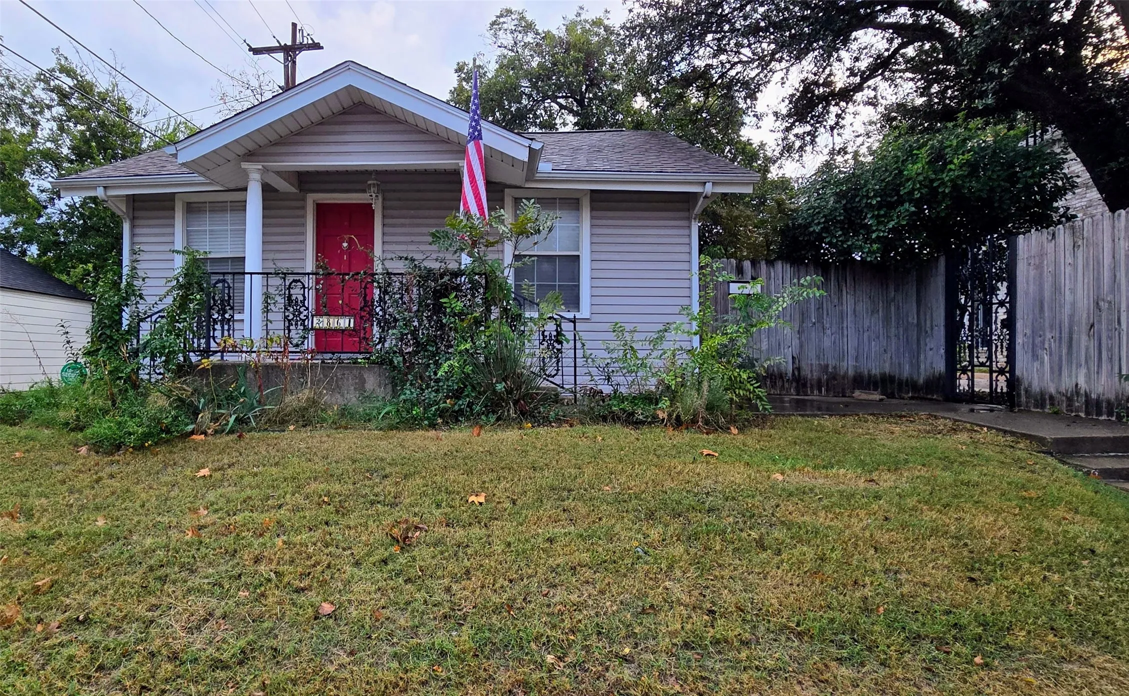Bungalow-style home featuring covered porch and a front lawn